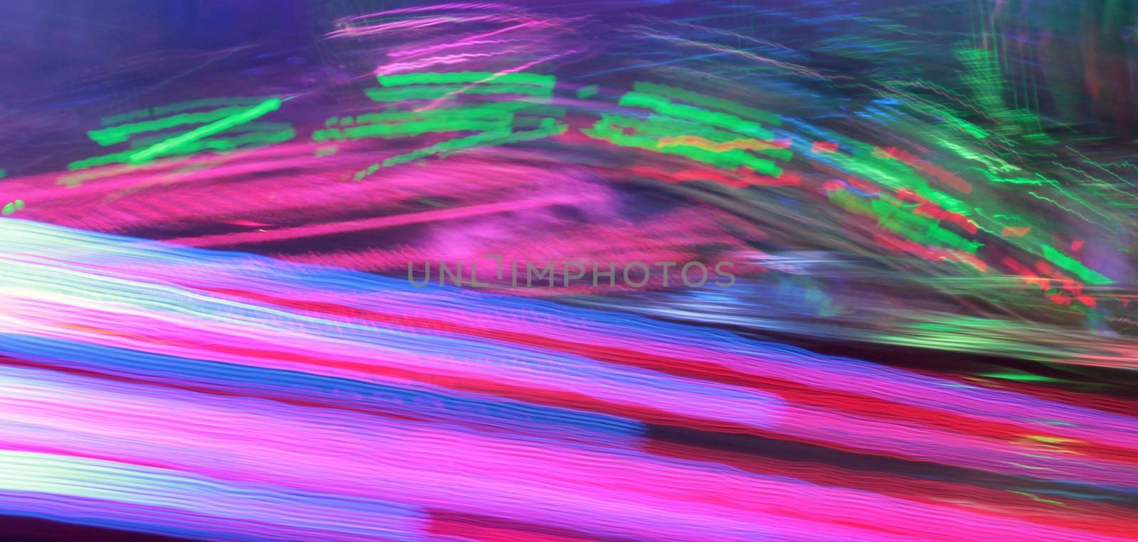 Night colors of the amusement park lights moving, light trails, slow shutter-speed