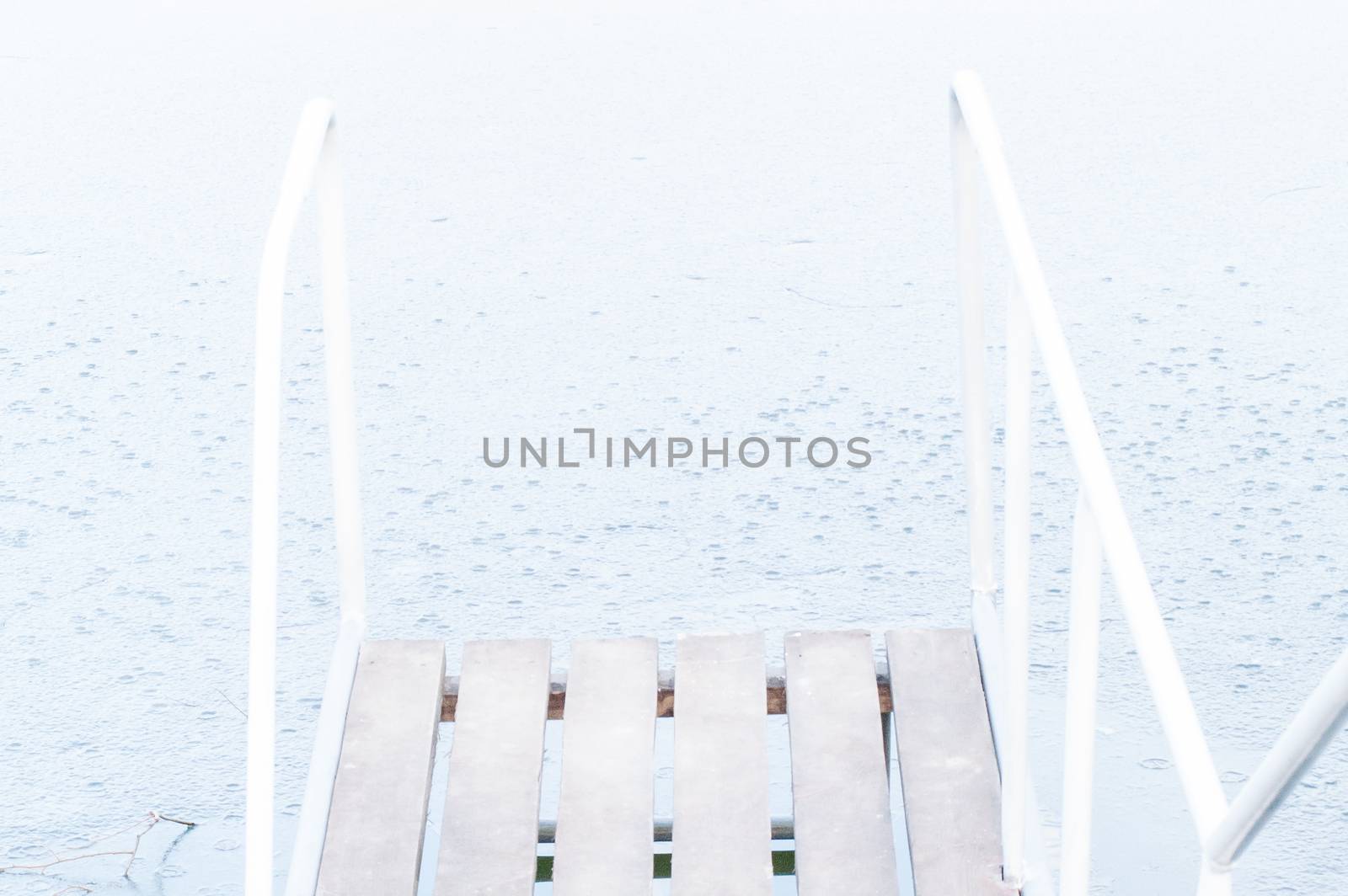 wooden pier, bridge of ice in the water