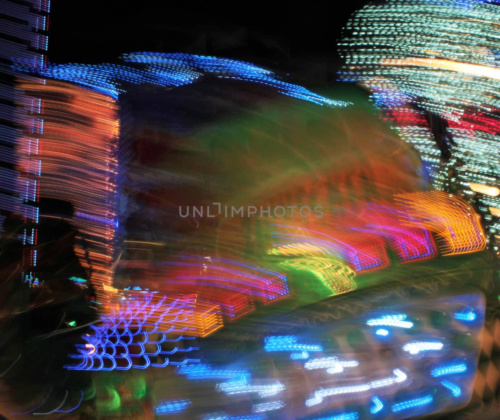 Night colors of the amusement park lights moving, light trails, slow shutter-speed