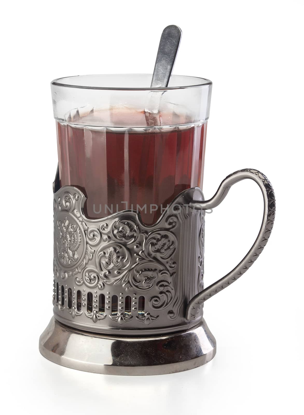 Isolated glass of black tea in the  metal glass holder
