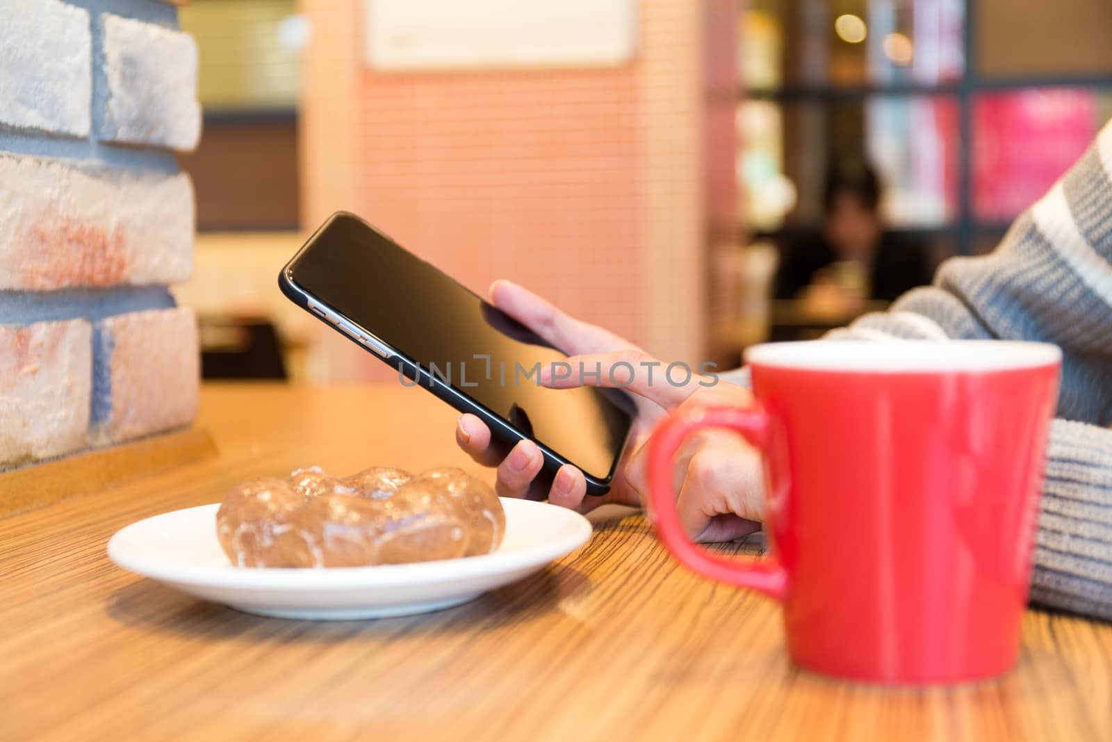 Woman use of the smart phone at cafe