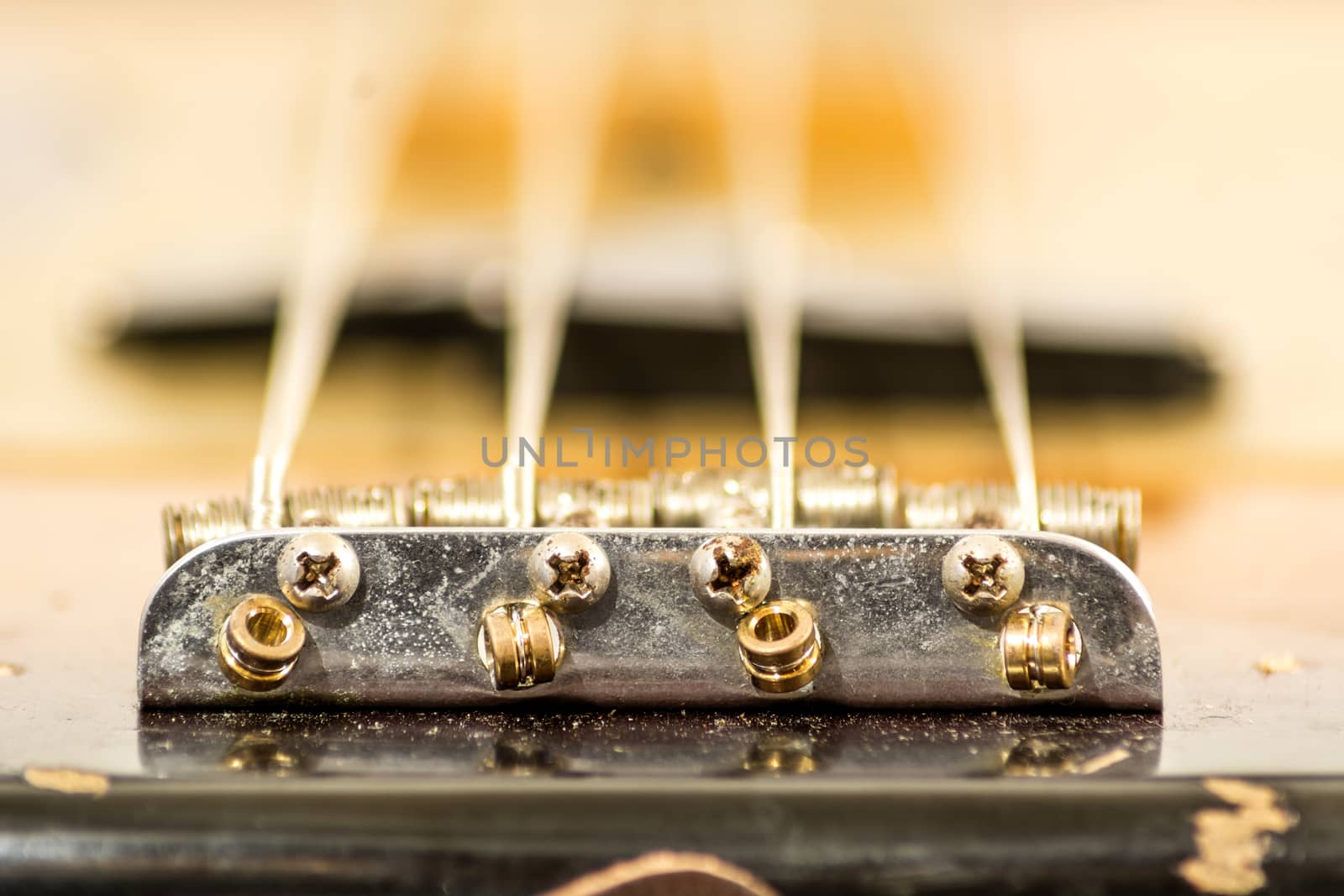 close up of a bridge in the body of an electric bass