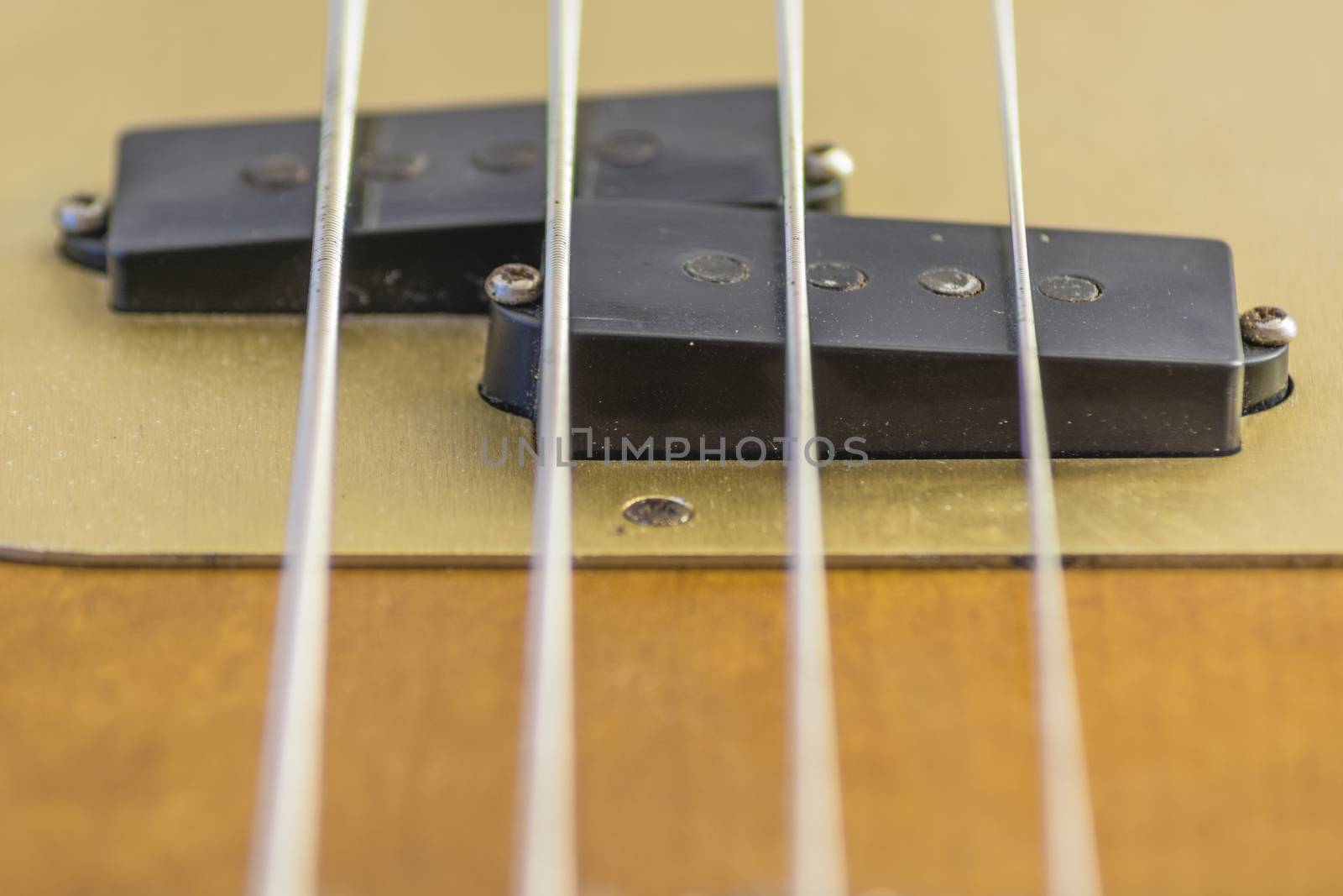 close up of pickips ofa a four strings electric bass