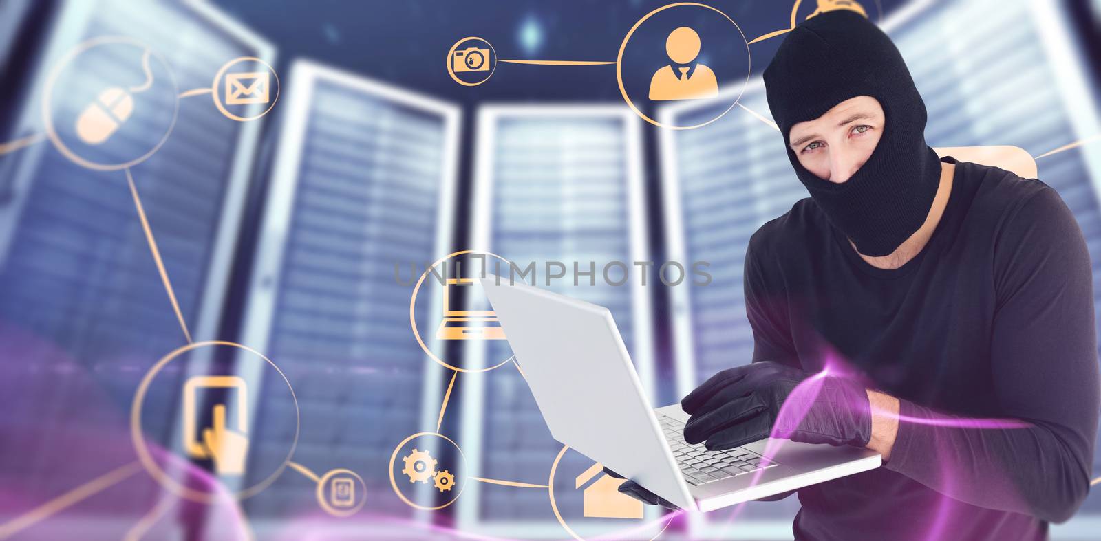 Burglar standing holding laptop while looking at camera against abstract glowing black background