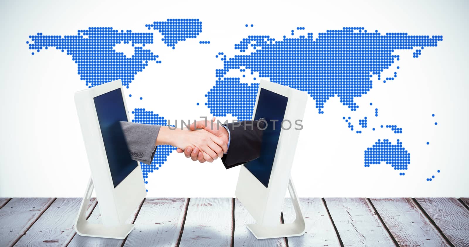 Close up of two businesspeople shaking their hands against computer on white background