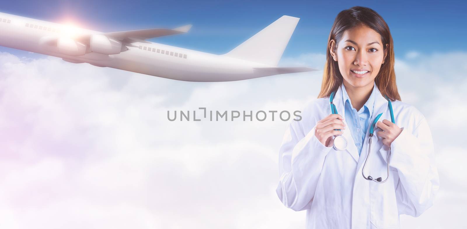 Asian doctor holding stethoscope against bright blue sky over clouds