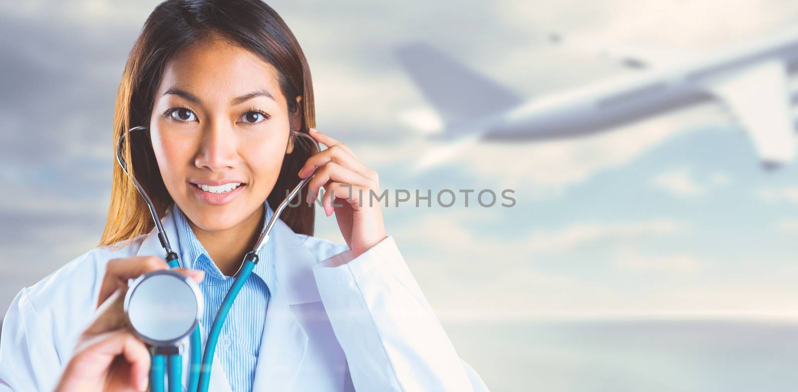 Asian doctor holding her stethoscope against bridge over water and blue sky