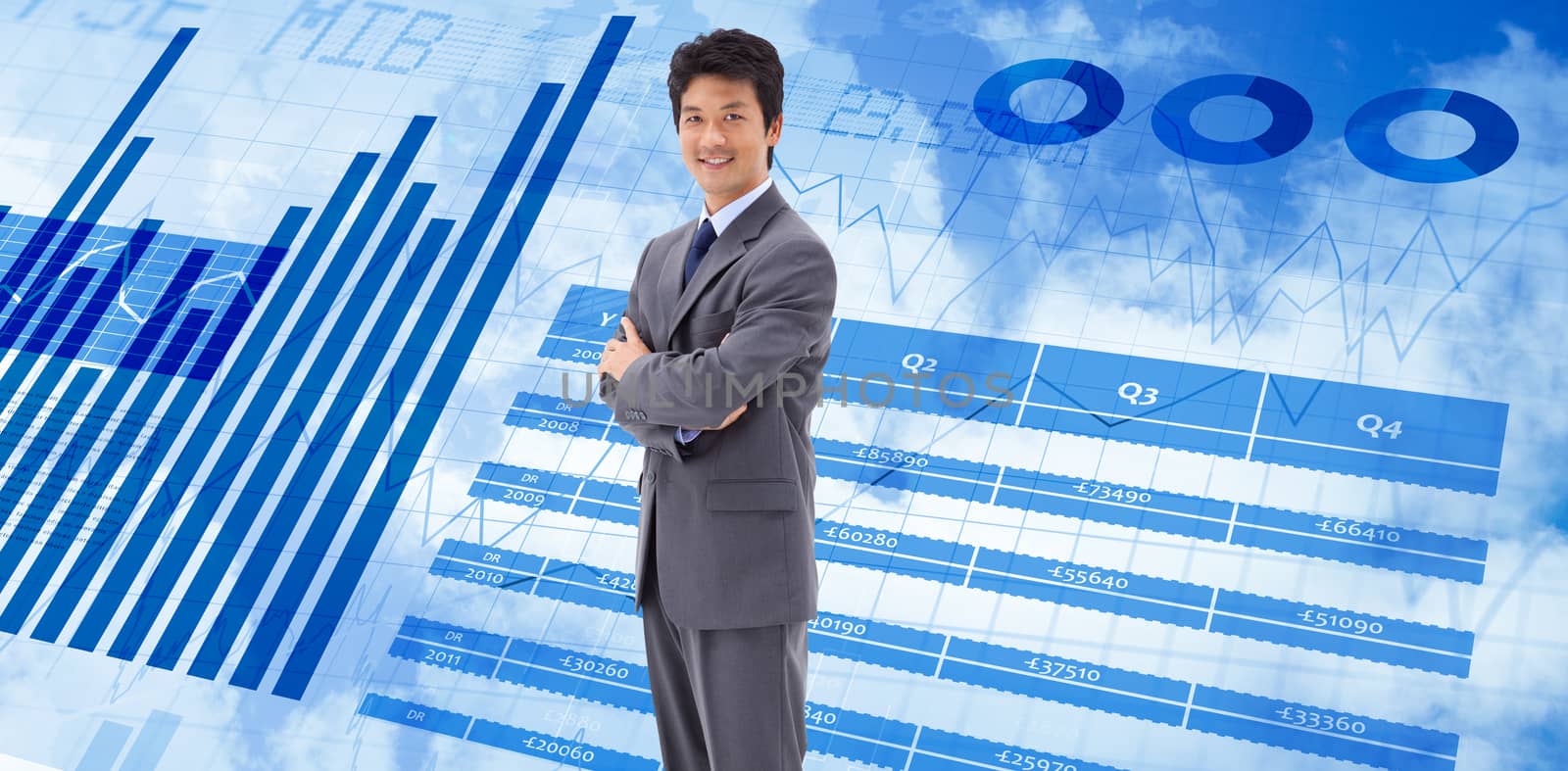 Portrait of a smiling businessman with the arms crossed against blue data