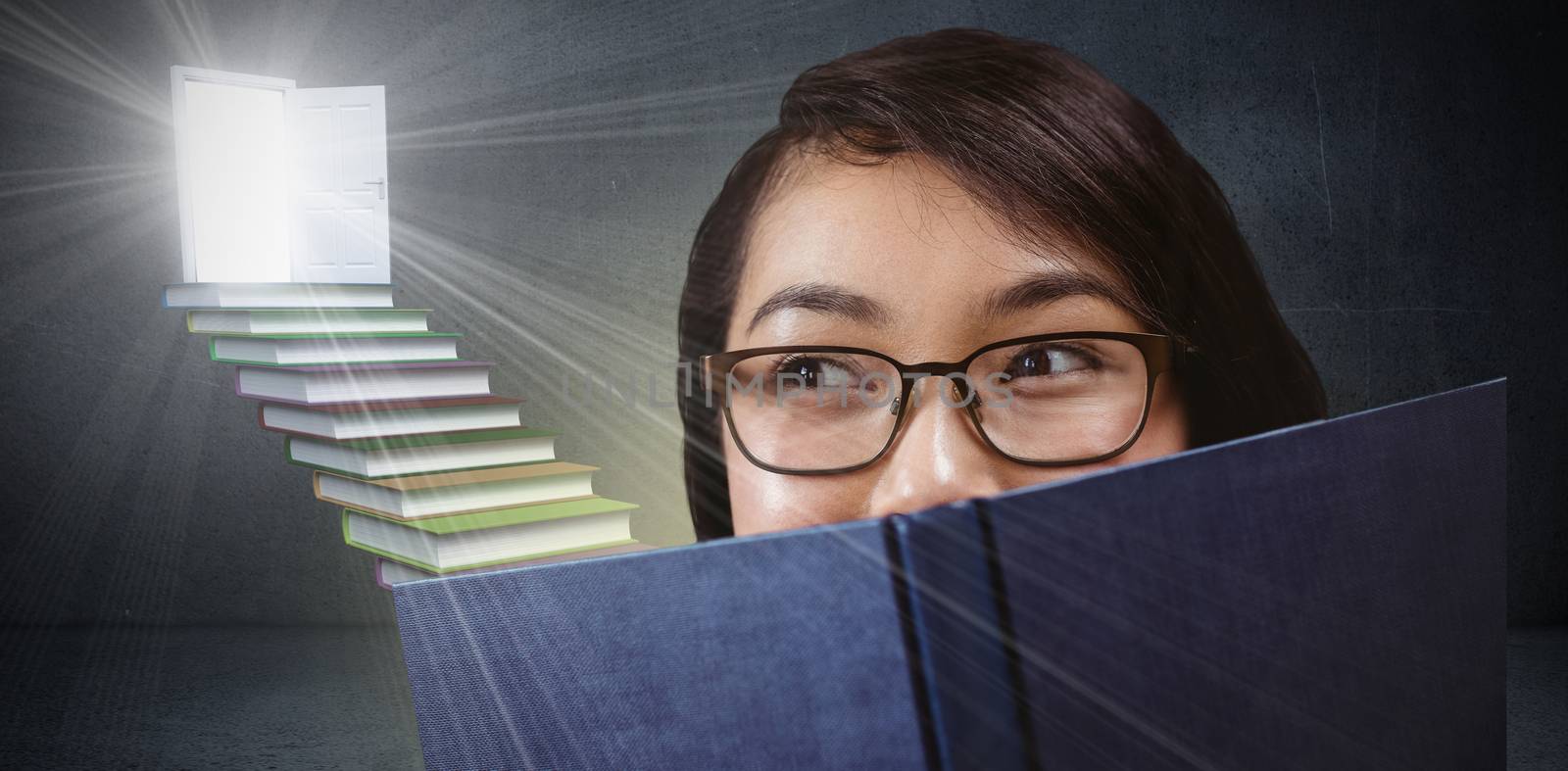 Composite image of pretty student hiding face behind a book by Wavebreakmedia