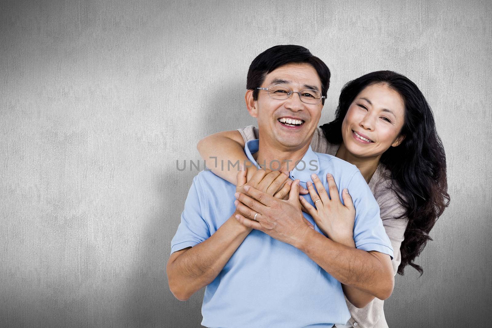 Composite image of smiling couple holding each other by Wavebreakmedia
