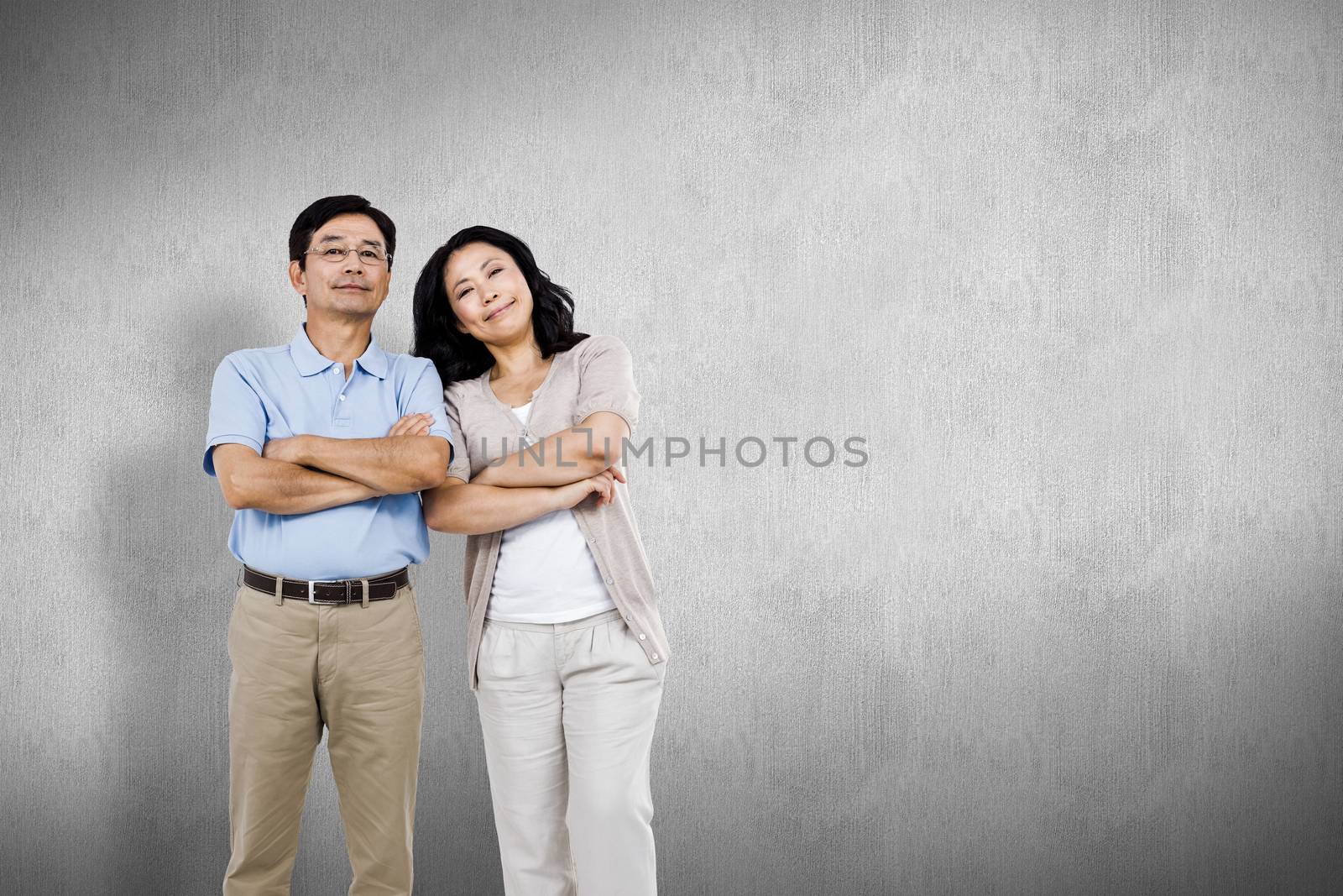 Composite image of smiling couple with arms folded by Wavebreakmedia