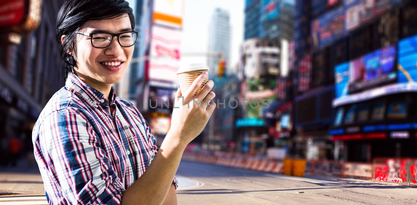 Smiling creative businessman with take-away coffee against blurry new york street