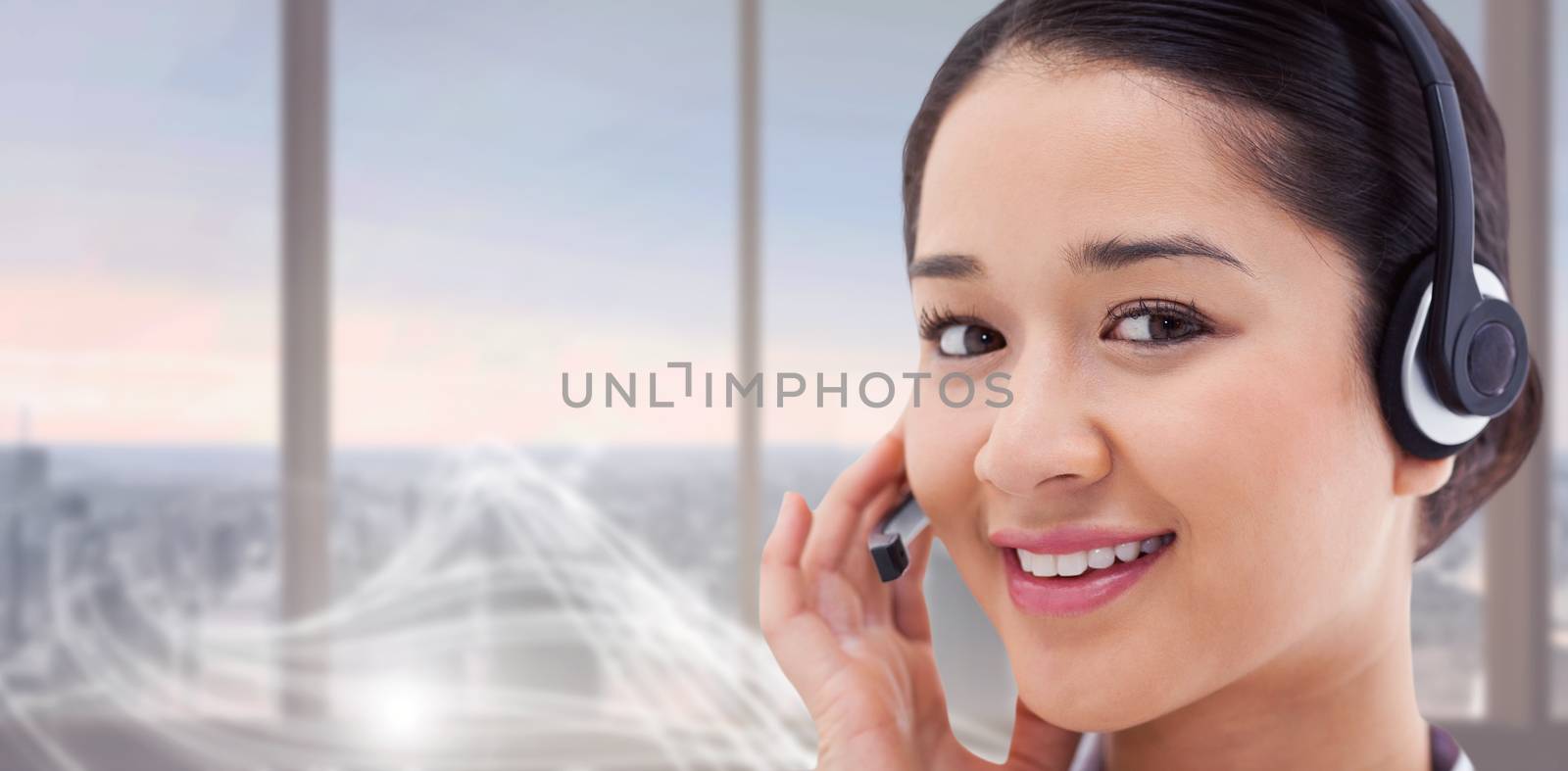 Composite image of close up of a smiling operator posing with a headset by Wavebreakmedia