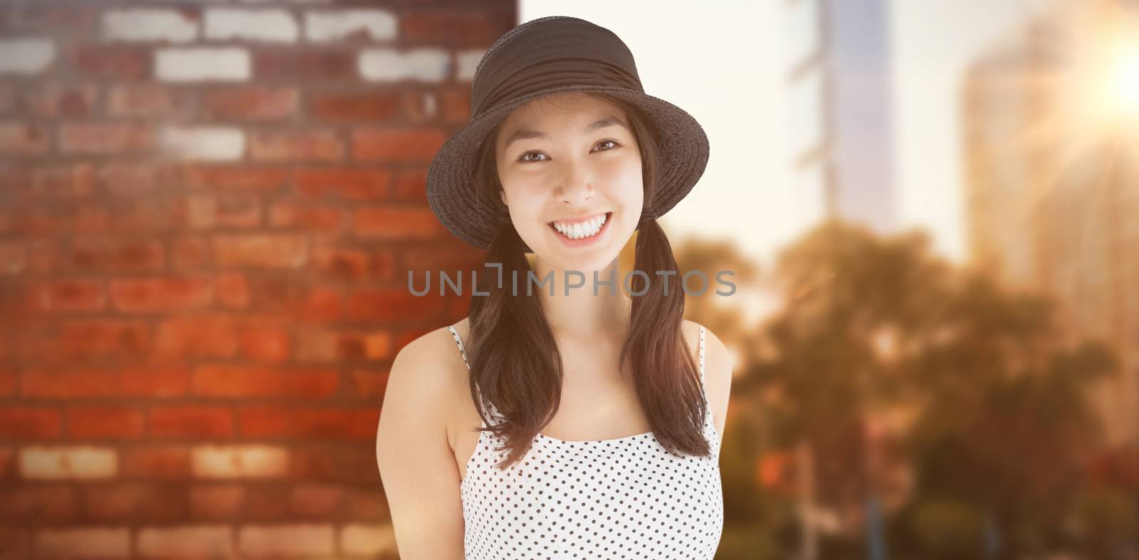 Composite image of cheerful woman with a polka dot dress and hat by Wavebreakmedia