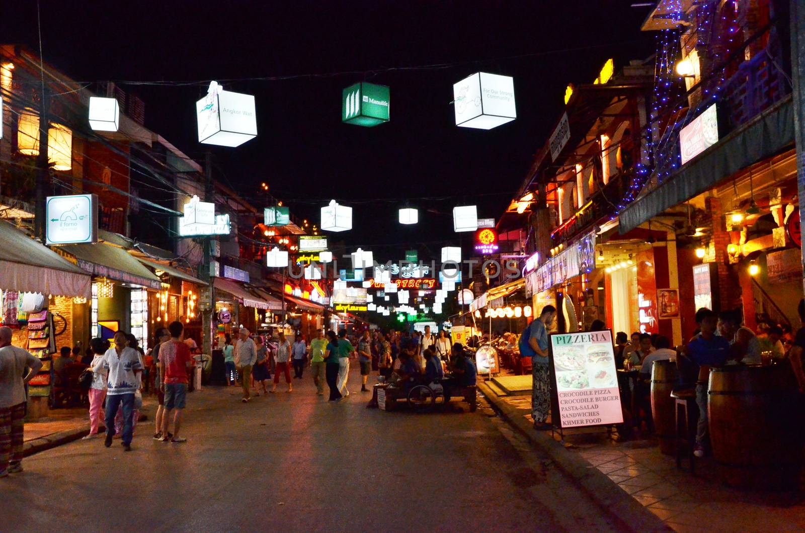 Siem Reap, Cambodia - December 2, 2015: Unidentified tourists shopping at the Pub street in Siem Reap, Cambodia. Pub street is the famous night market of Siem Reap.