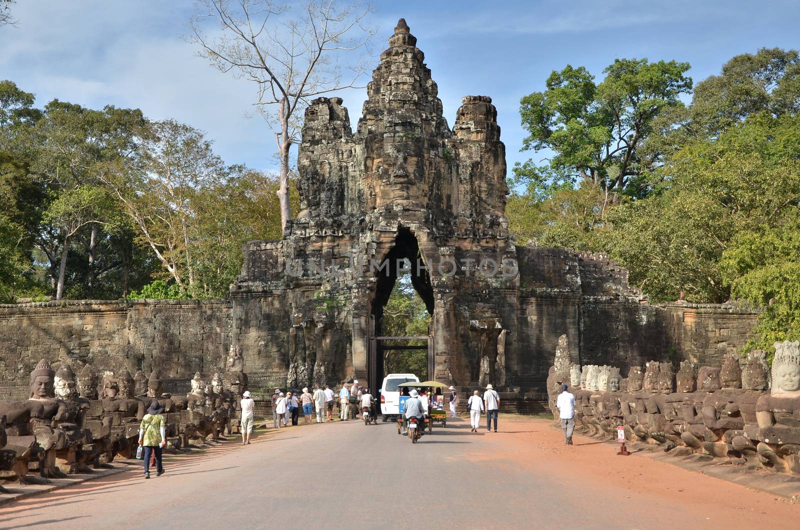 Siem Reap, Cambodia - December 4, 2015: Tourists at South gate to Angkor Thom in Siem Reap. by siraanamwong