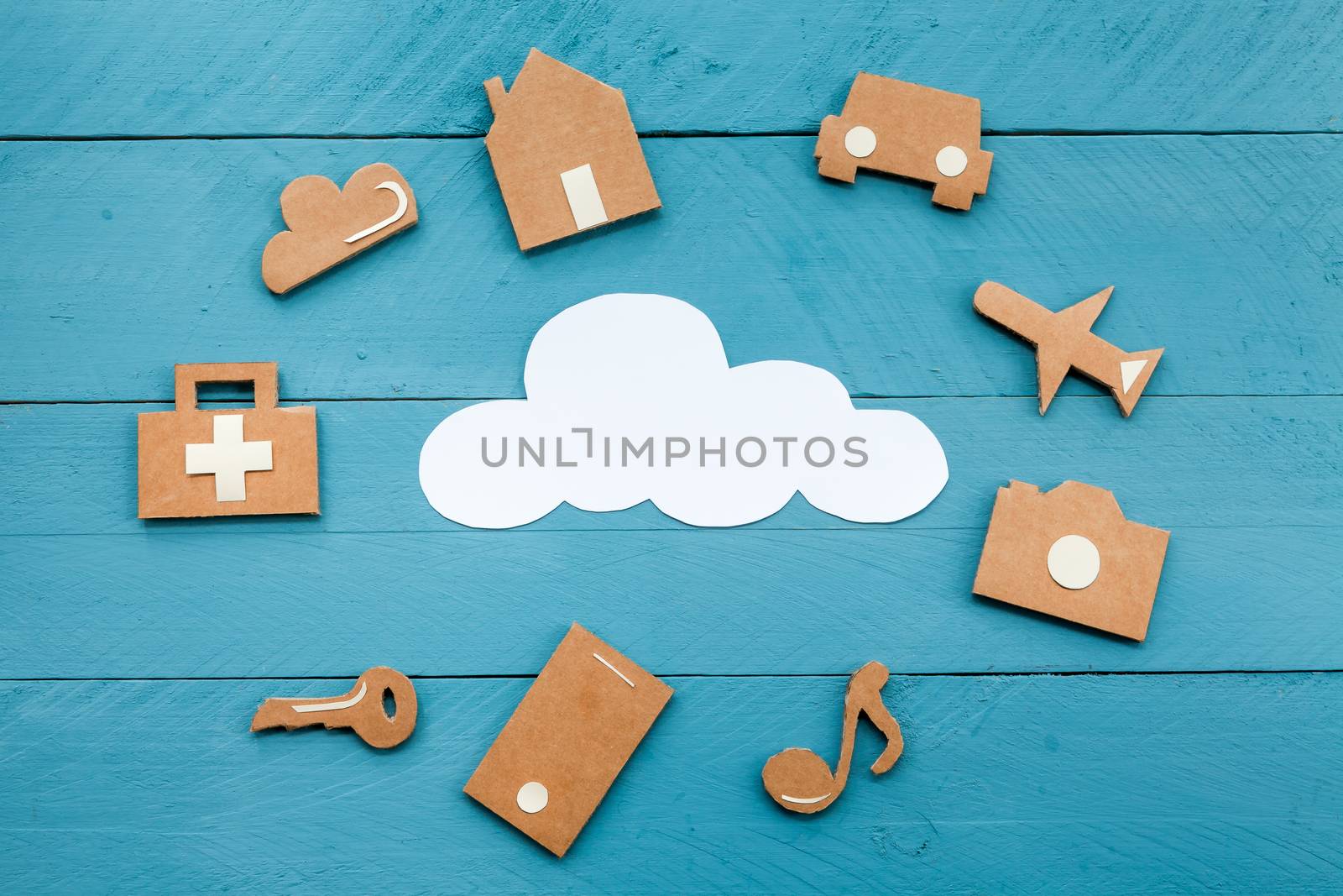 Cardboard web icons  and white cloud on blue background by andongob