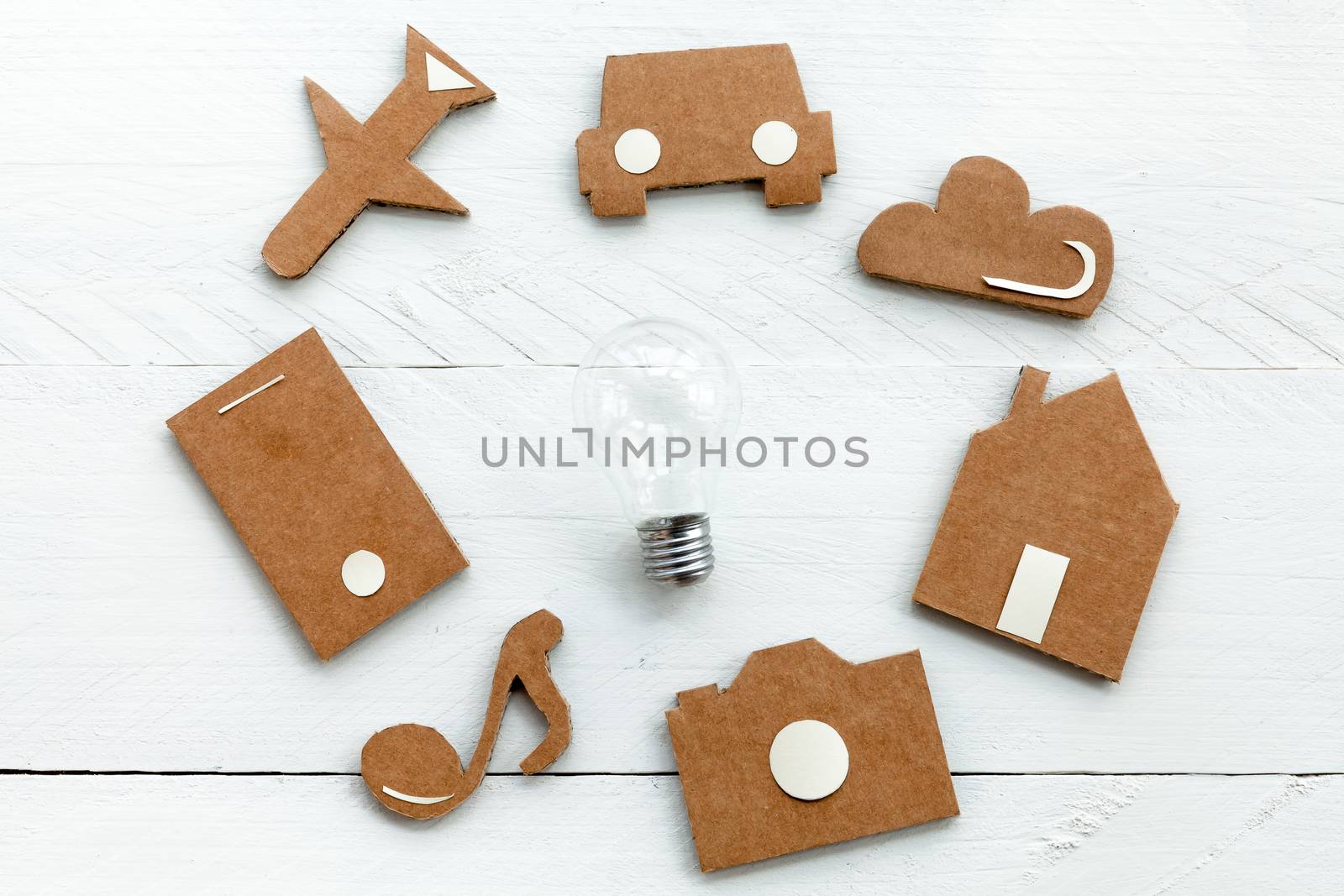 Set of web icons or graphical illustrations cut from cardboard and placed on blue wooden background