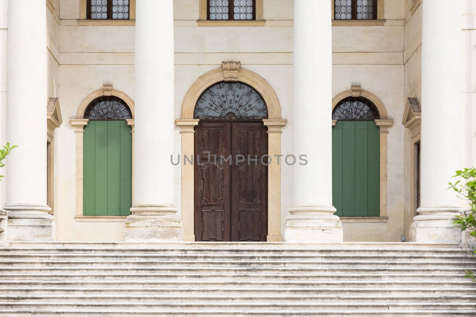 Detail of the entrance of a Venetian villa with white stone columns.