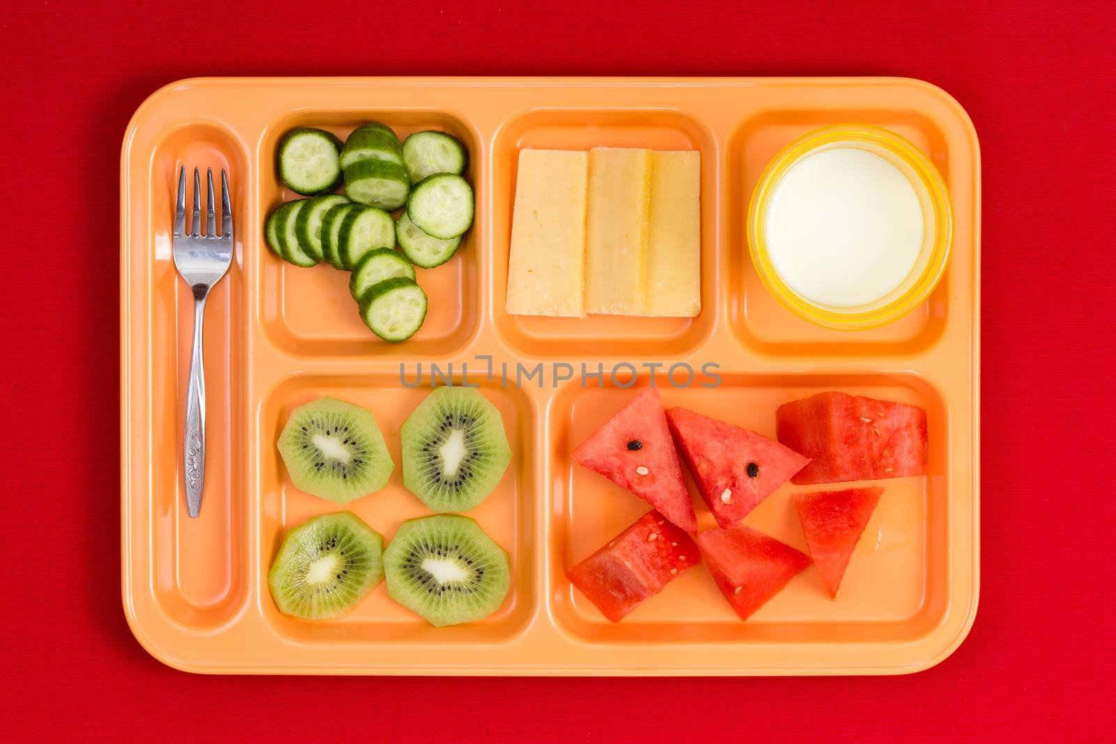 Lunch tray with fork, fruit, cheese and milk by coskun