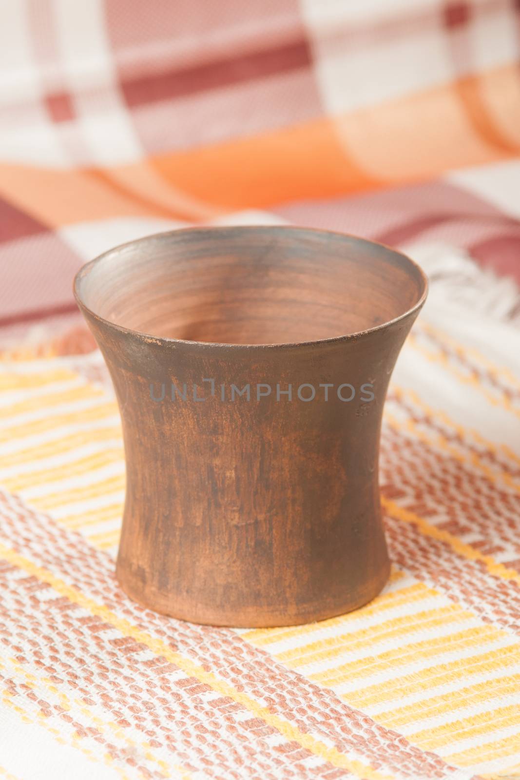 Traditional handcrafted mug on multycolor background