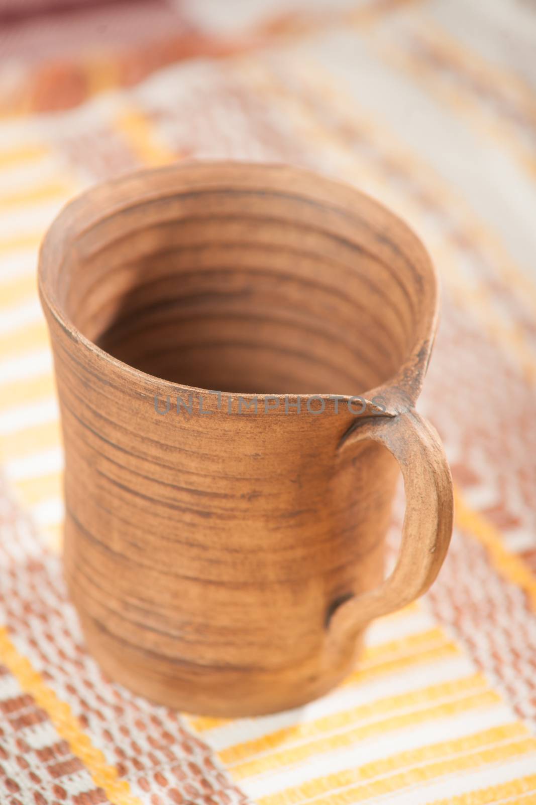 Traditional handcrafted mug on multycolor background by kozak