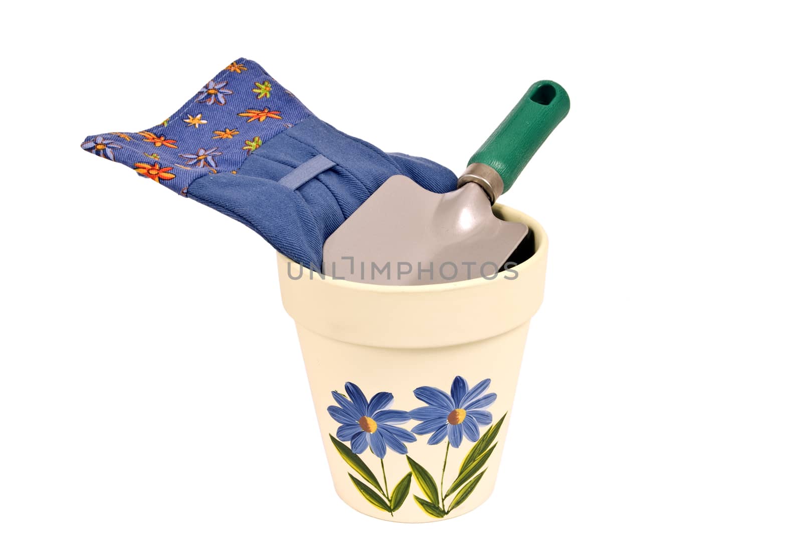 Vertical shot of a pretty flower pot with gloves and trowel.  Isolated on white.