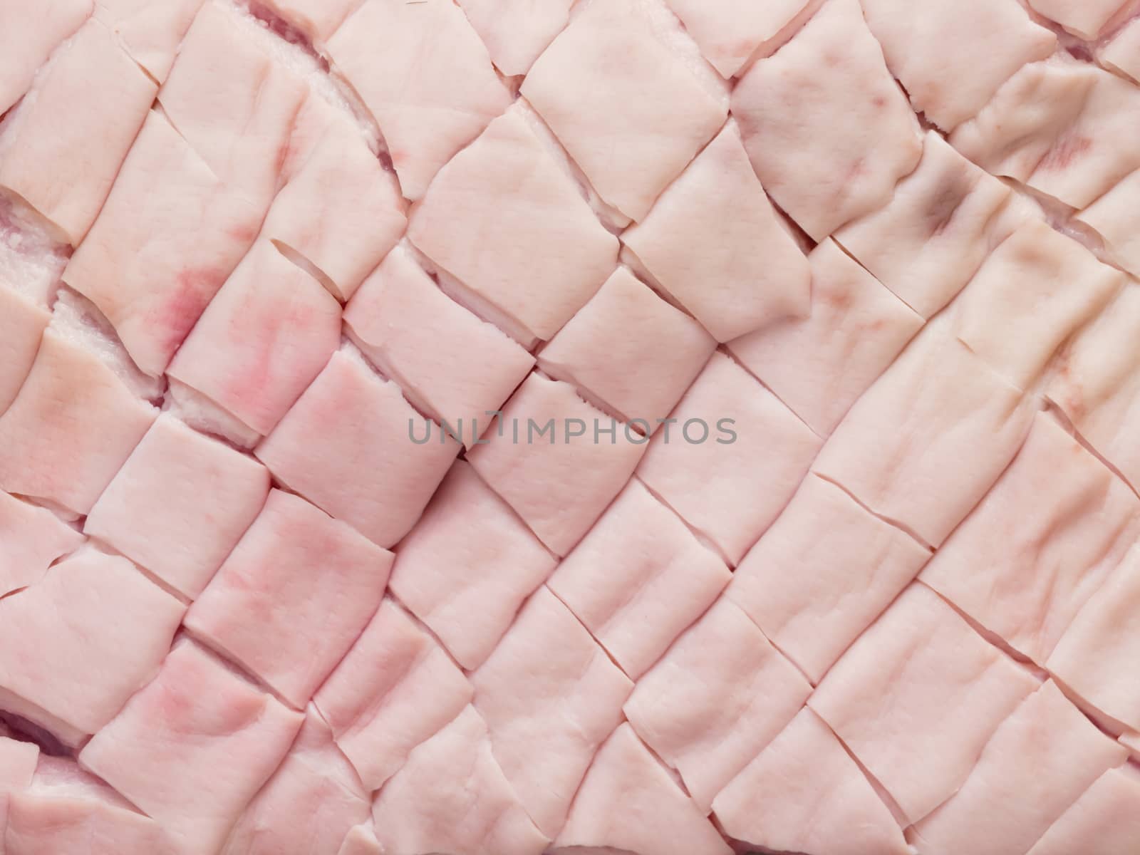 close up of raw uncooked scored pork belly skin food background