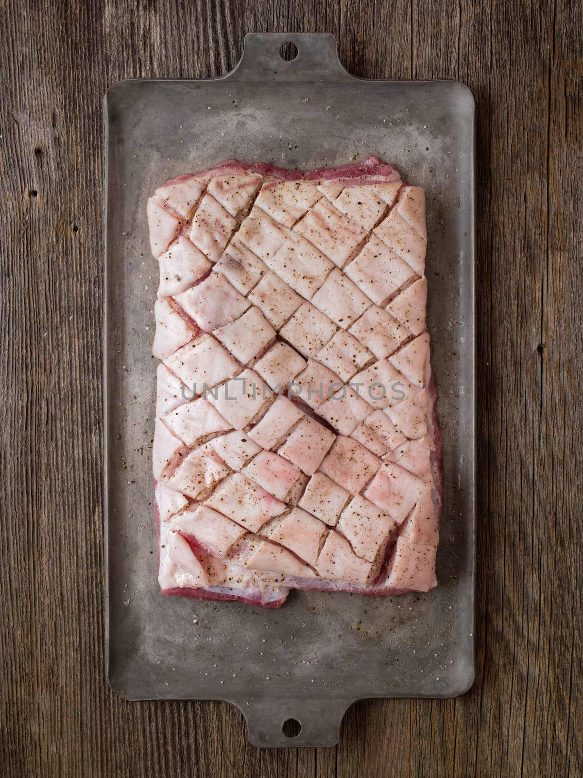 close up of rustic raw uncooked seasoned pork belly