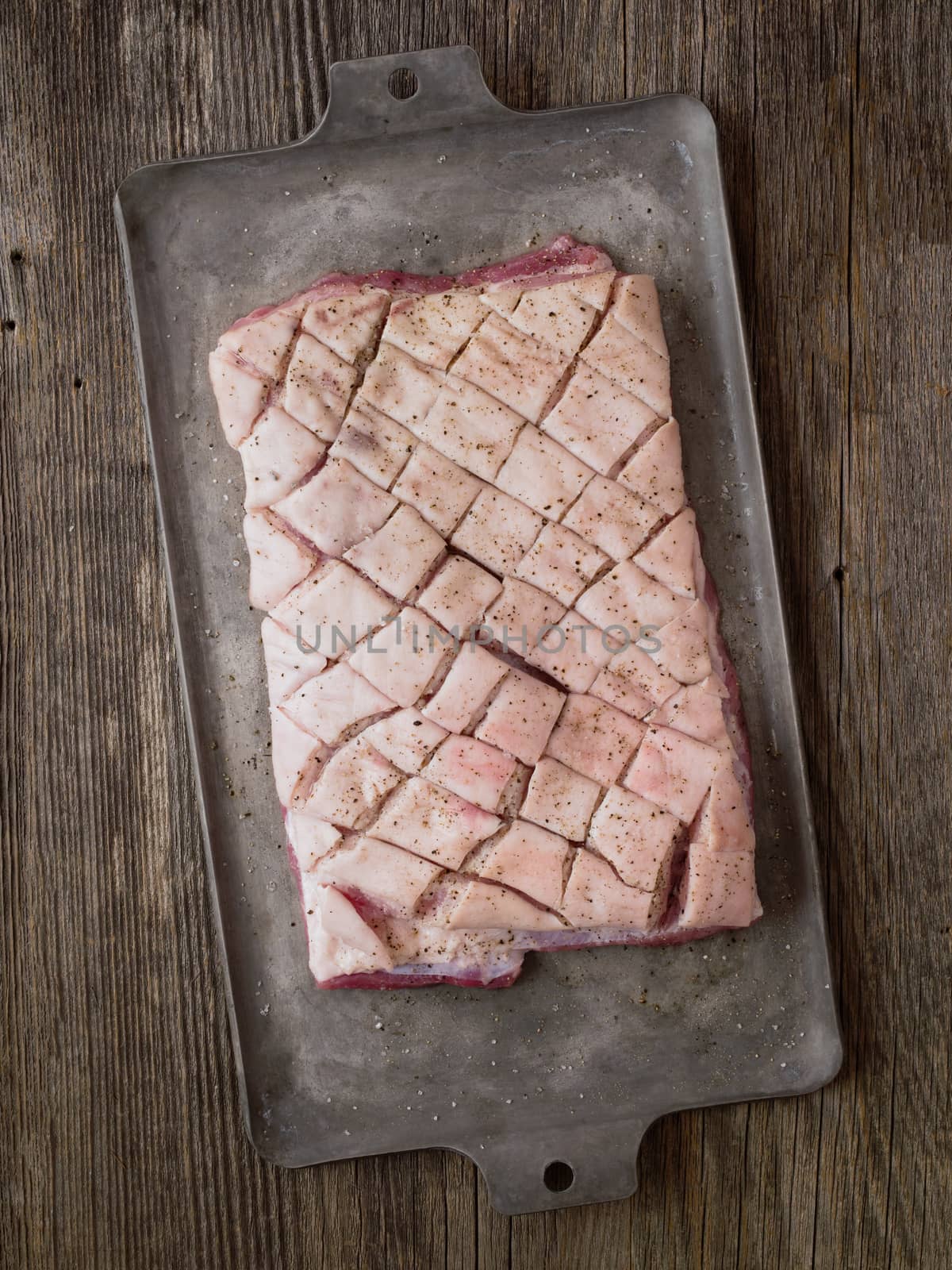 rustic raw uncooked seasoned pork belly by zkruger