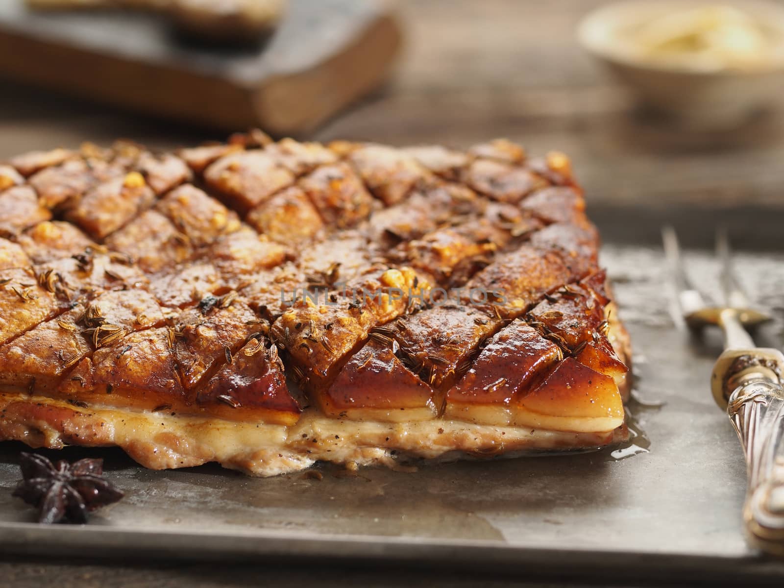 close up of rustic golden roasted pork belly