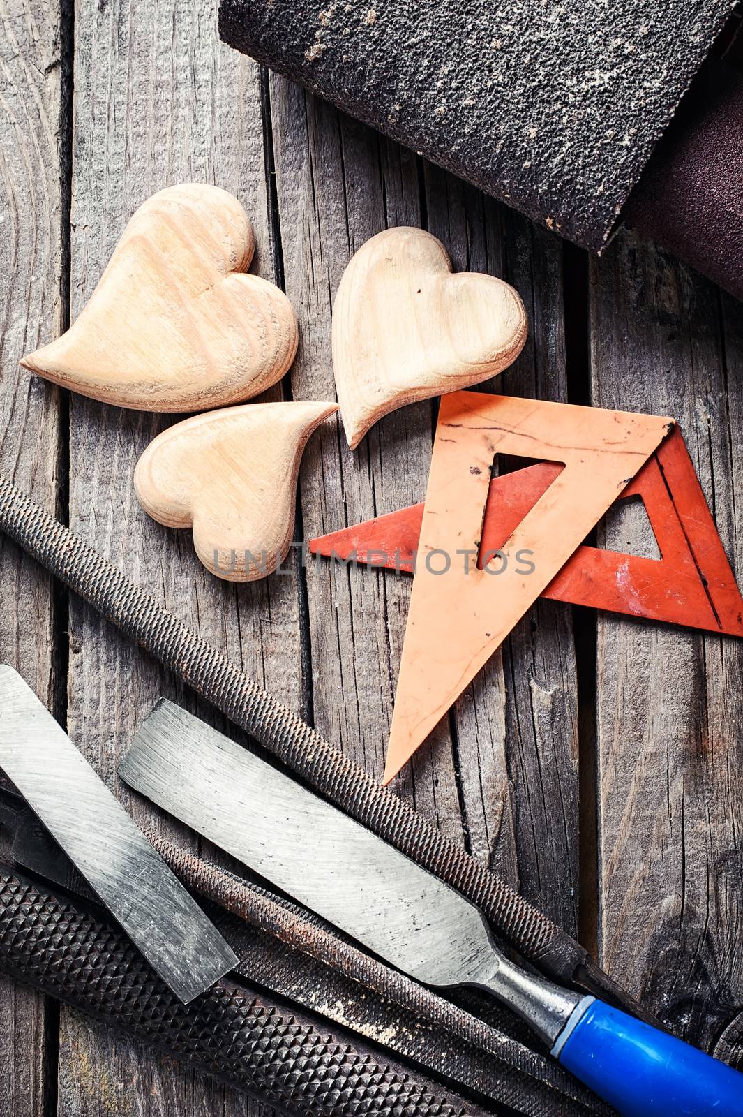 Symbolic wooden hearts cut by hand and carpenter tools