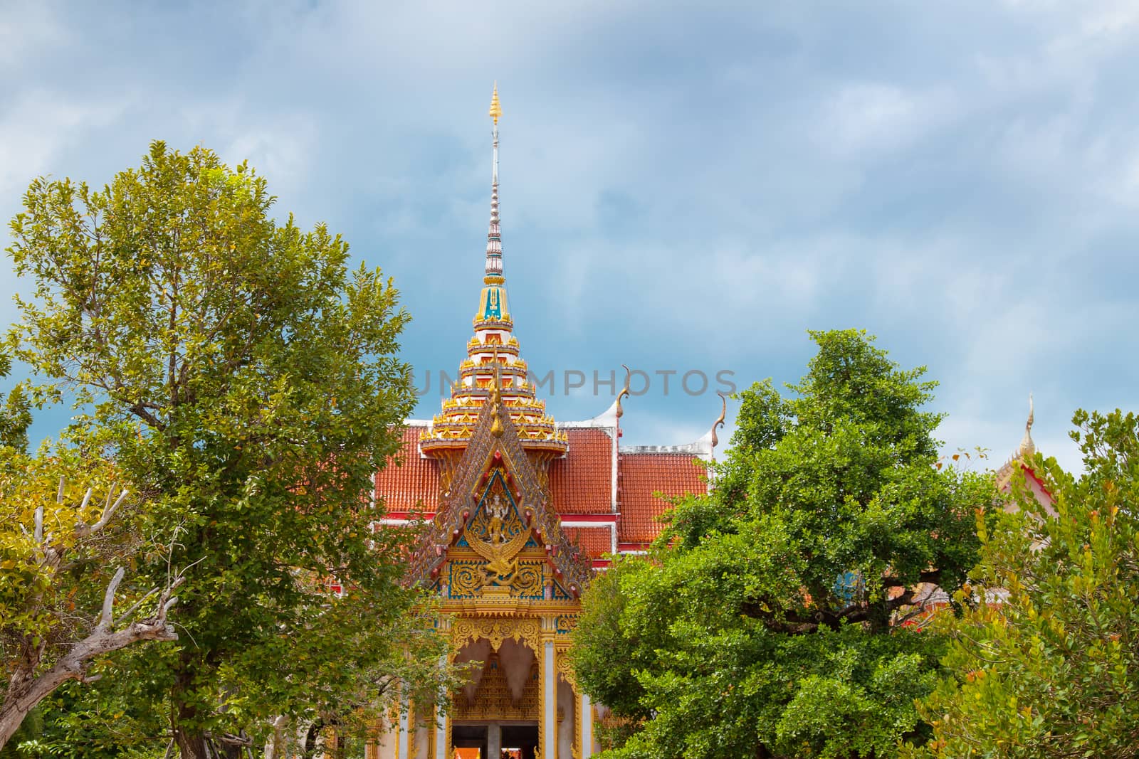 Buddhist asian gold decorated sanctuary on background of cloudy sky