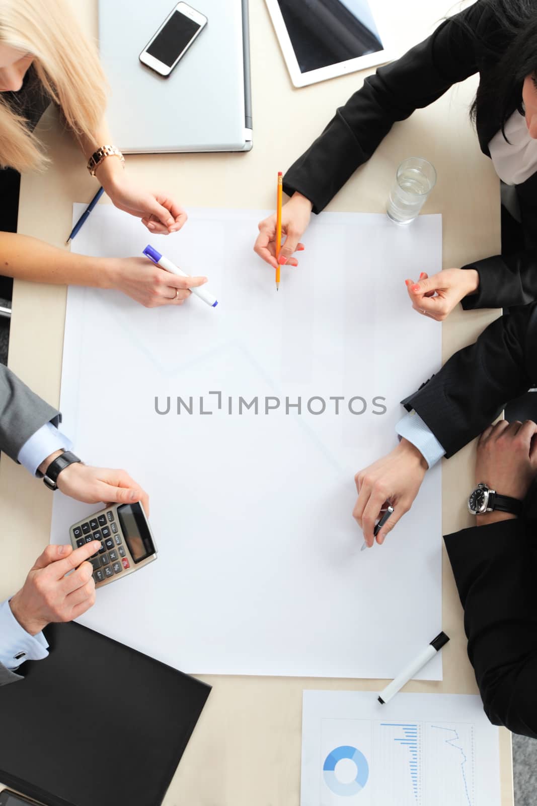 Business people sitting at table with electronic devices on meeting