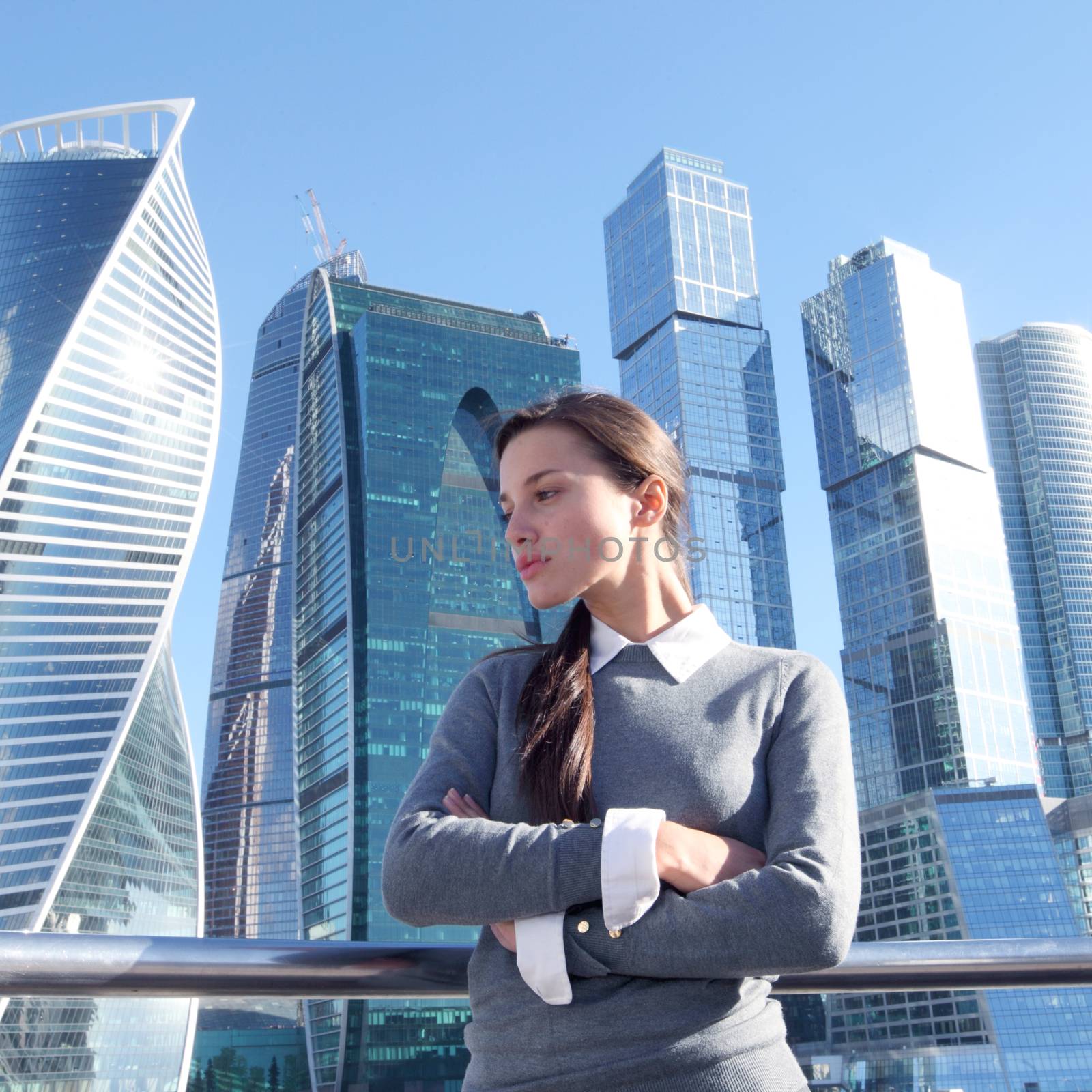 Young beautiful businesswoman outdoors at skyscraper background