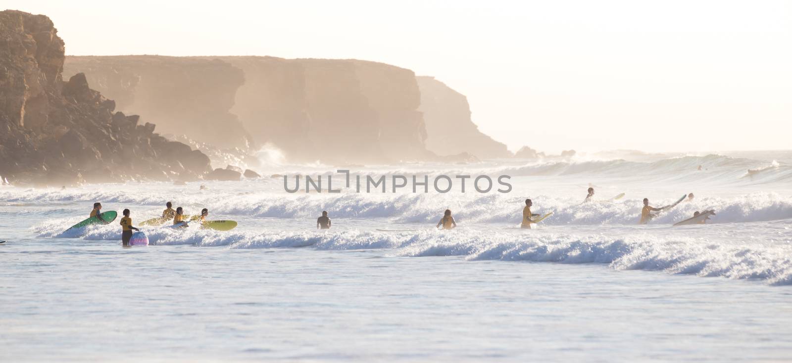 Surfers surfing on El Cotillo beach, Fuerteventura, Canary Islands, Spain. by kasto