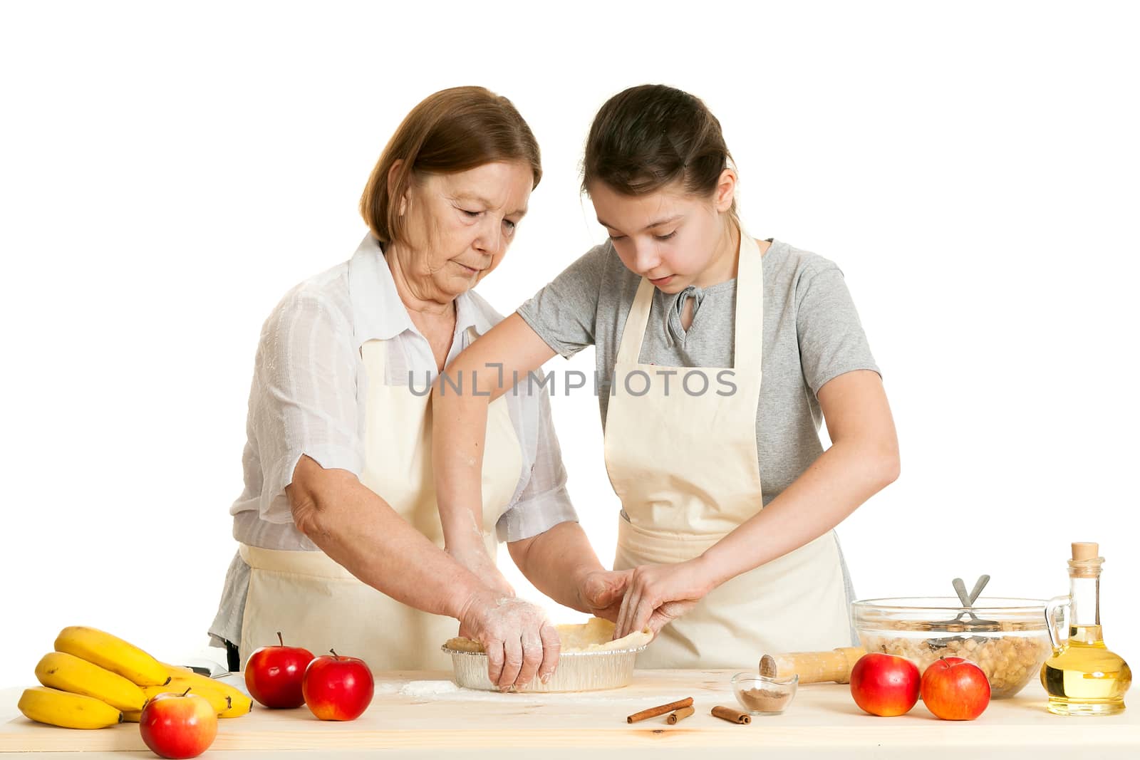 the grandmother and the granddaughter stack dough by sveter