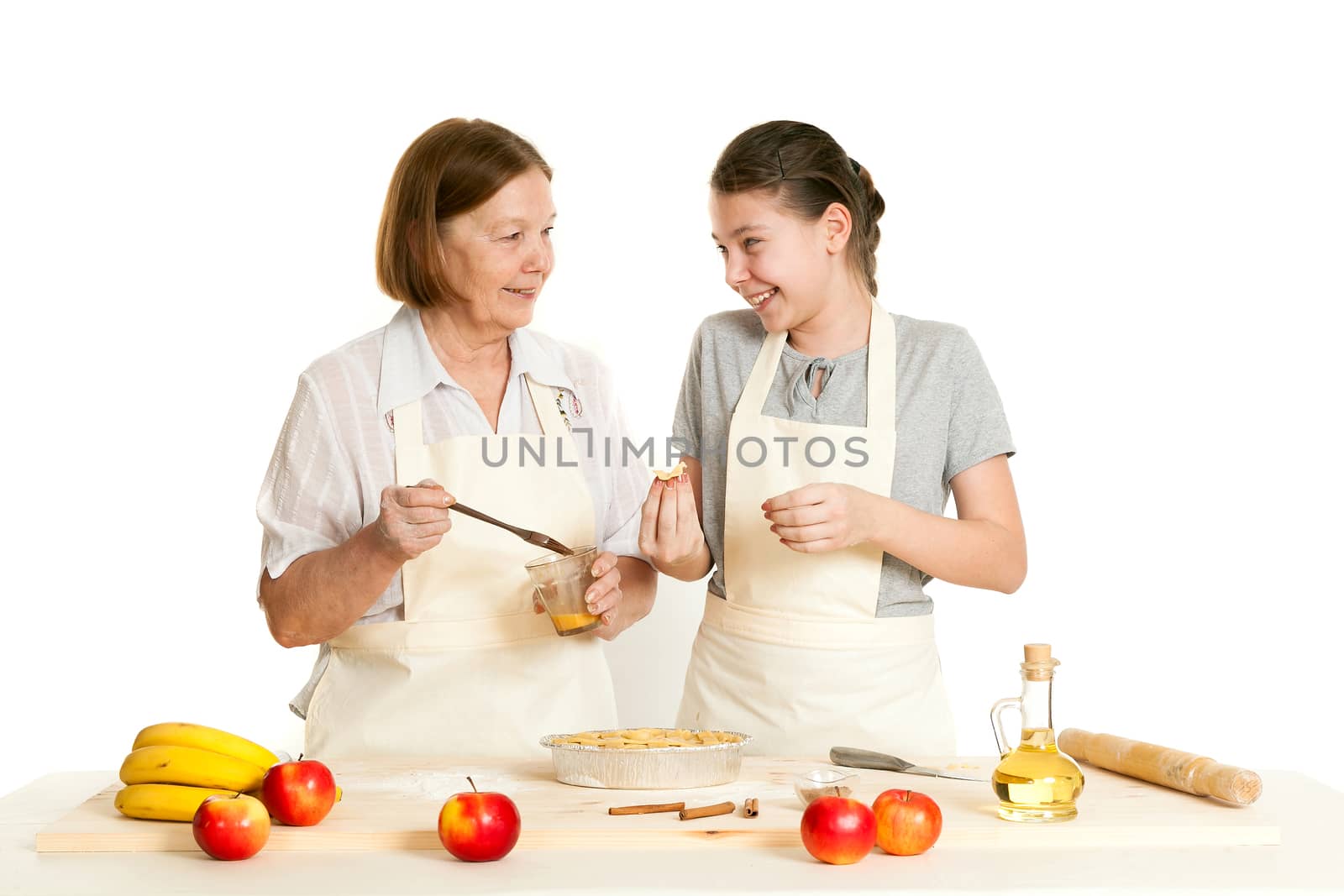 the grandmother and the granddaughter grease pie with a brush with egg