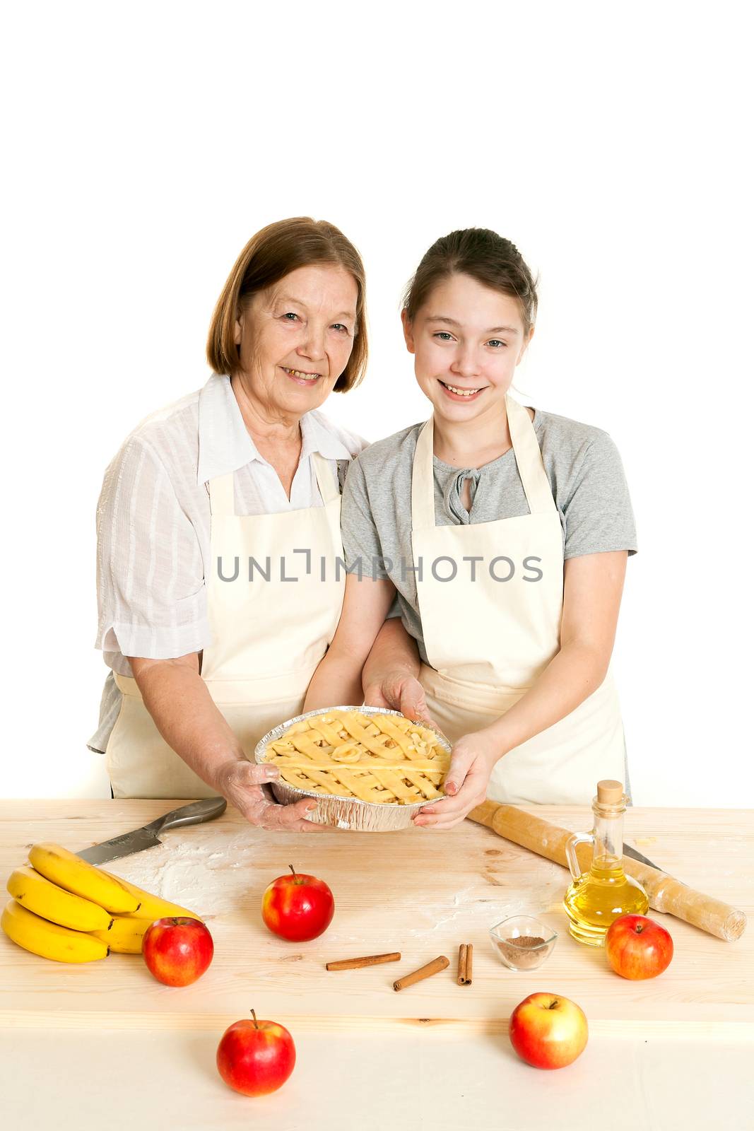 the grandmother and the granddaughter hold beautiful pie in hand