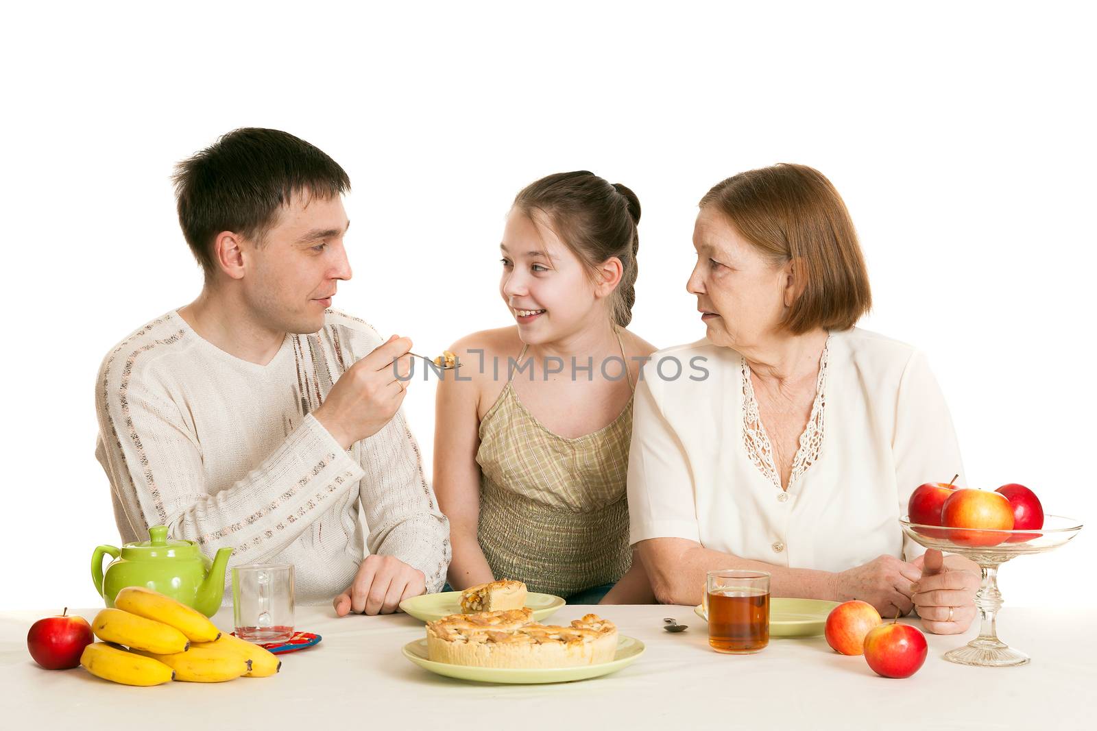 the father treats the daughter with pie about the grandmother at a table