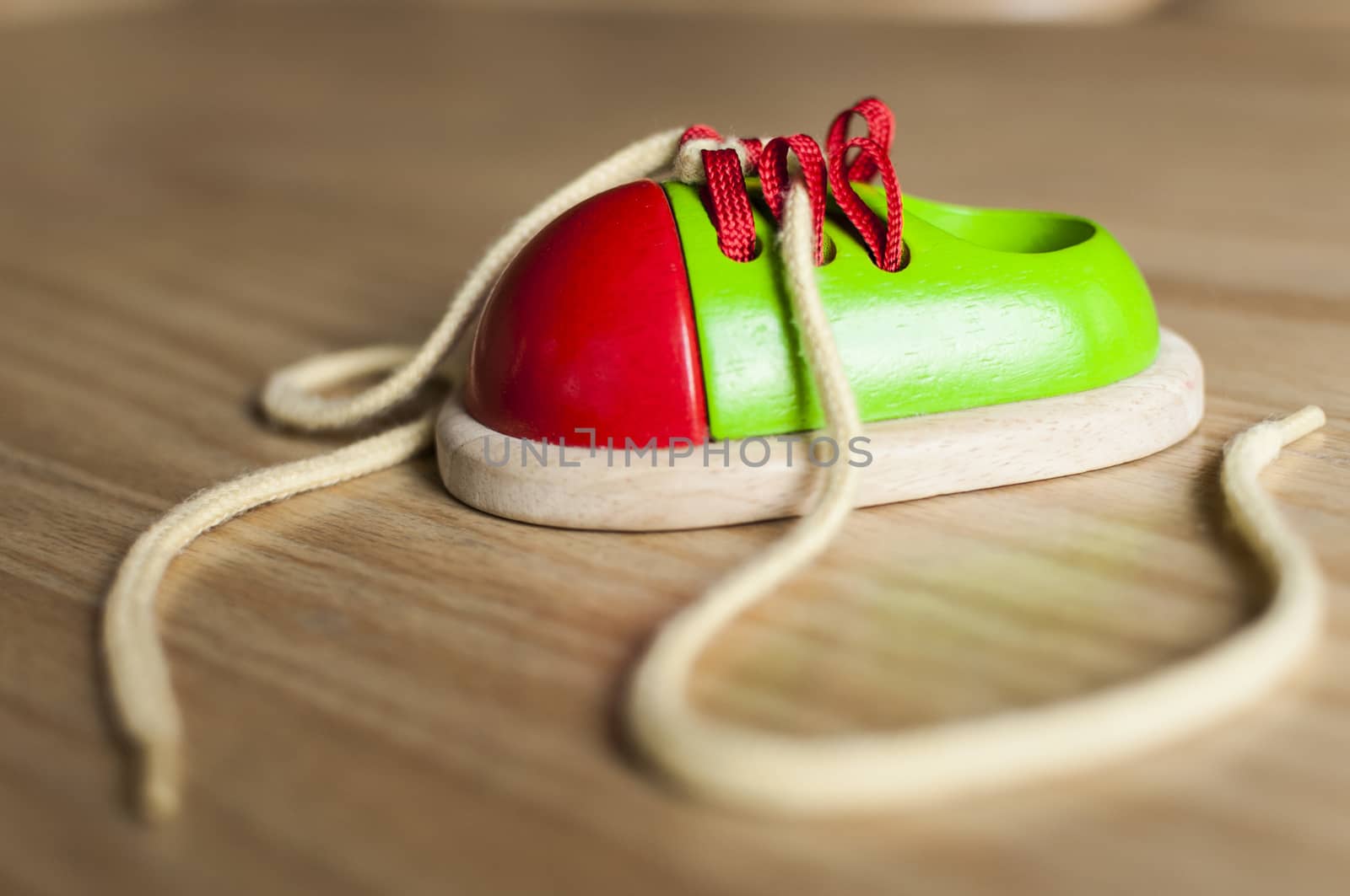 Ornamental shoe toy made of wood with shoelaces