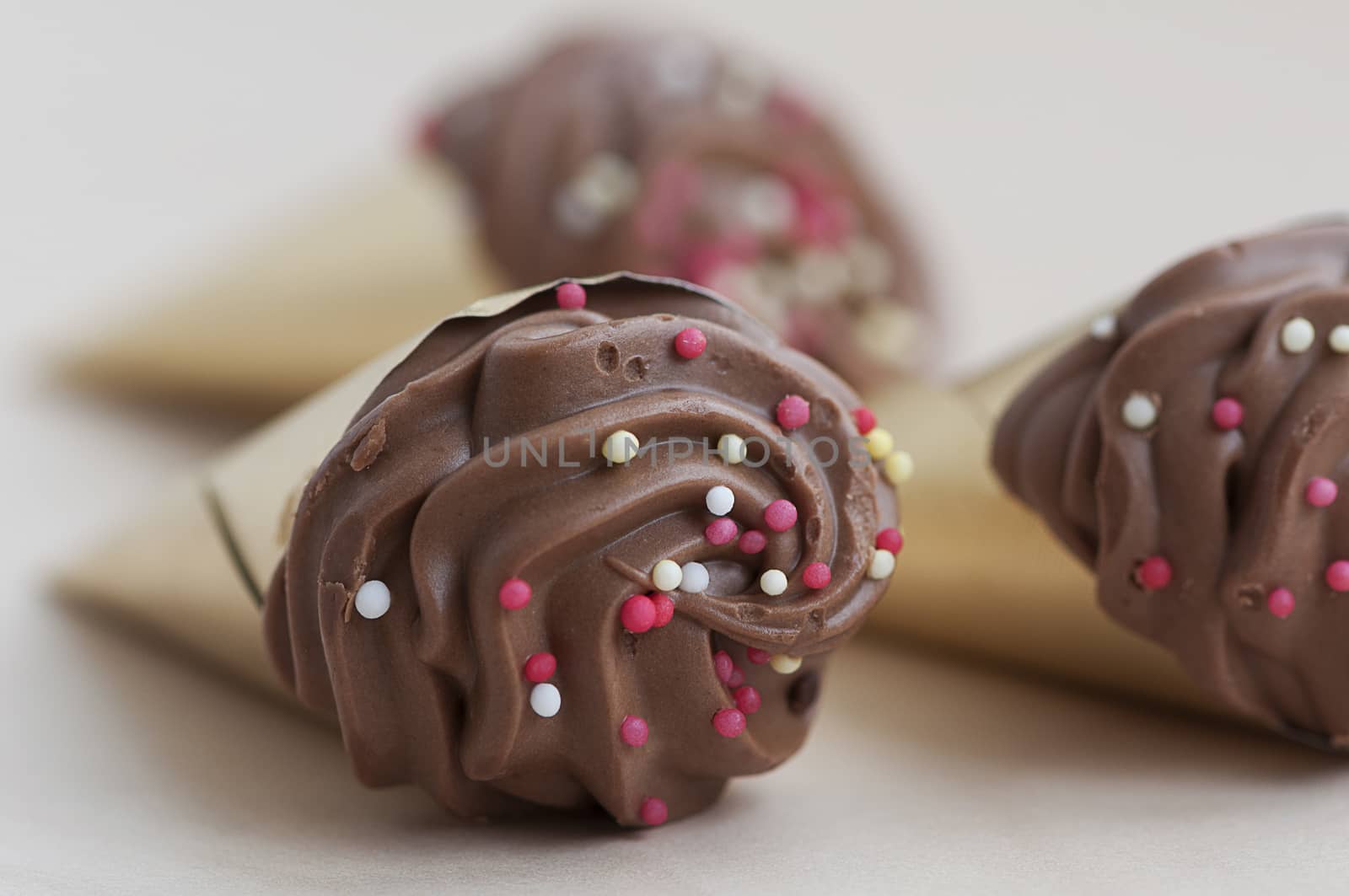 Closeup of a chocolate cone isolated on a wooden table