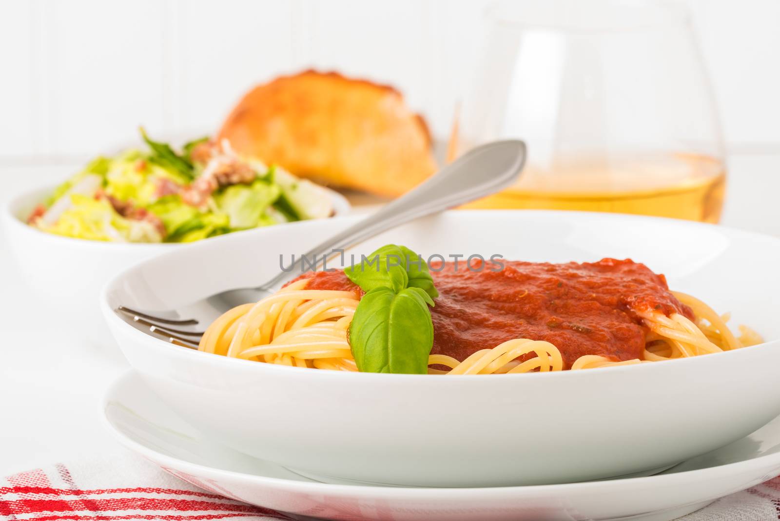 Bowl of spaghetti with tomato sauce.  Useful for menus or other food service applications.