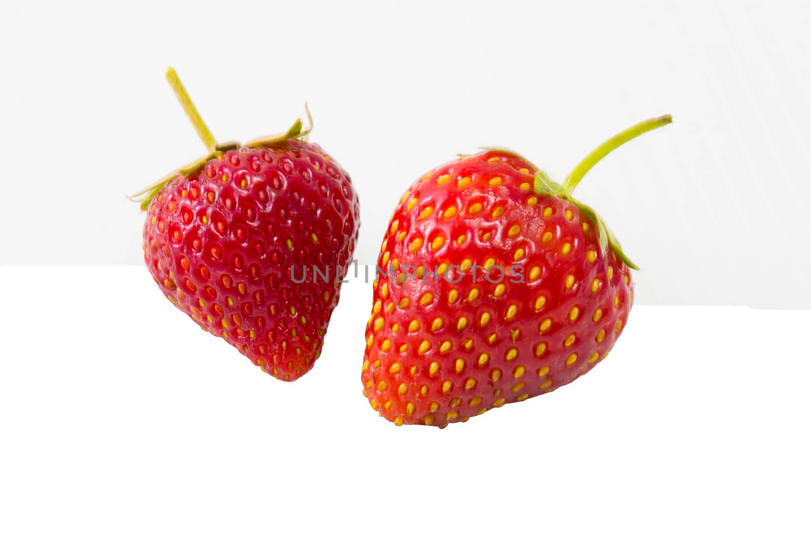Fresh red strawberry isolated on white background by chingraph