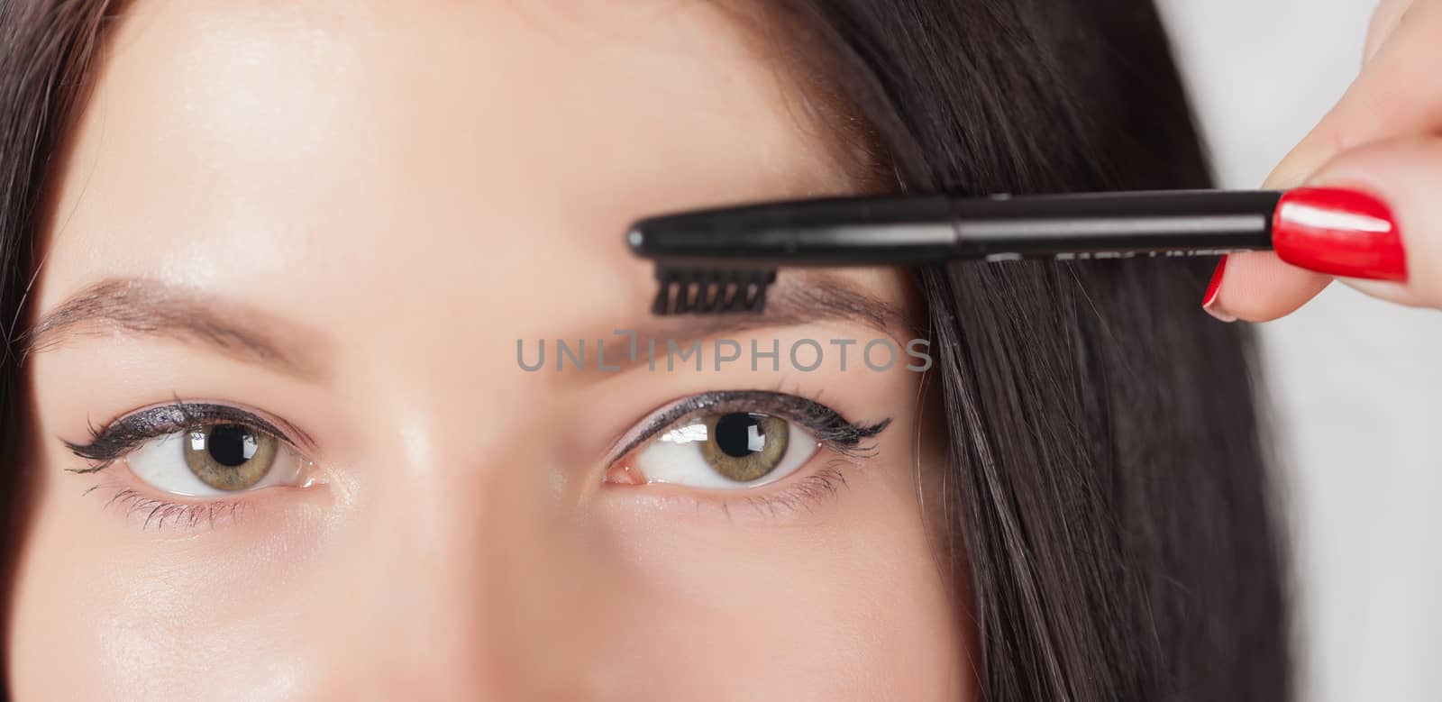 young woman doing her makeup, eyes closeup