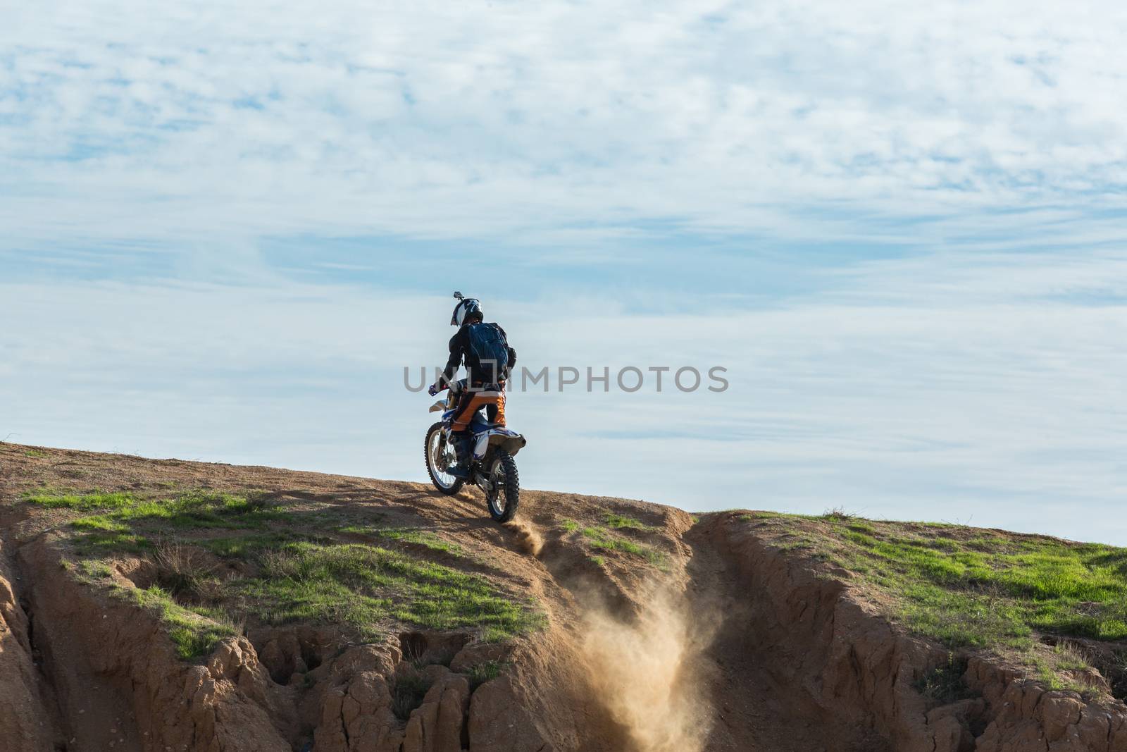 racer on a motorcycle in the desert summer day