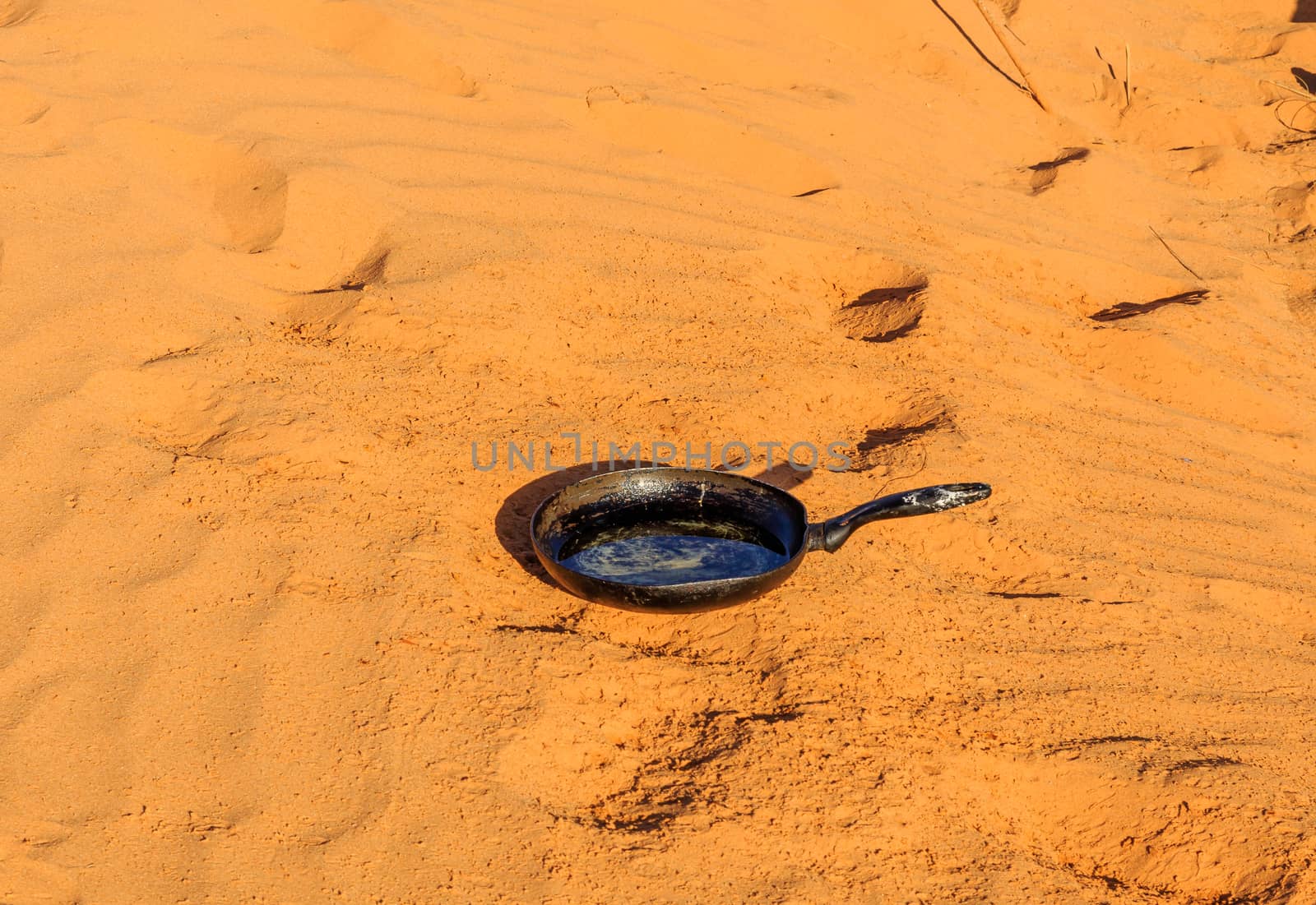 pan stands on sand in the desert by Mieszko9