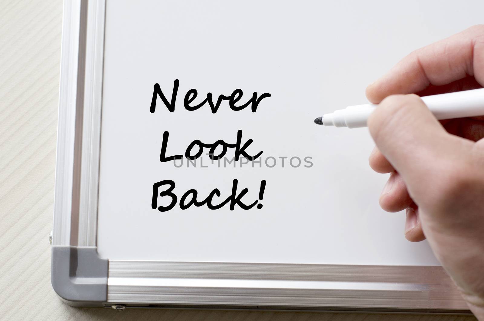 Never look back written on whiteboard by eenevski