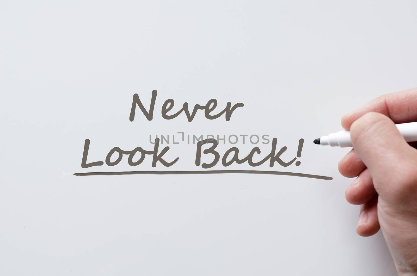Never look back written on whiteboard by eenevski