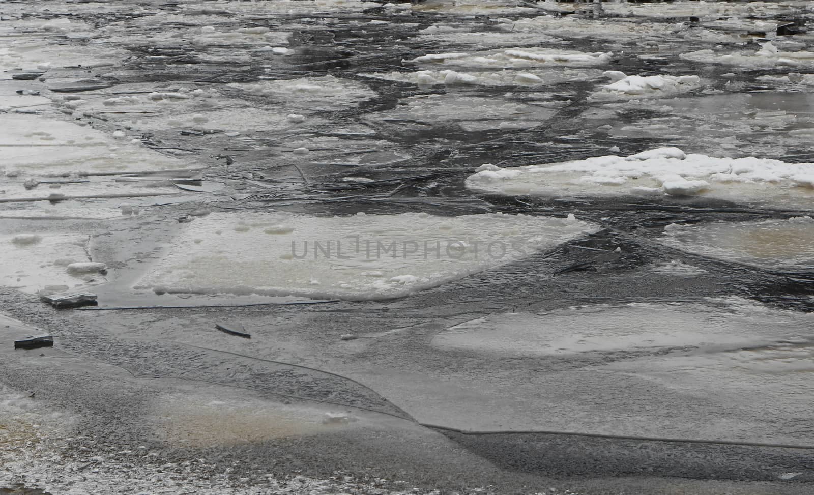Winter nature background with blocks of ice on frozen water